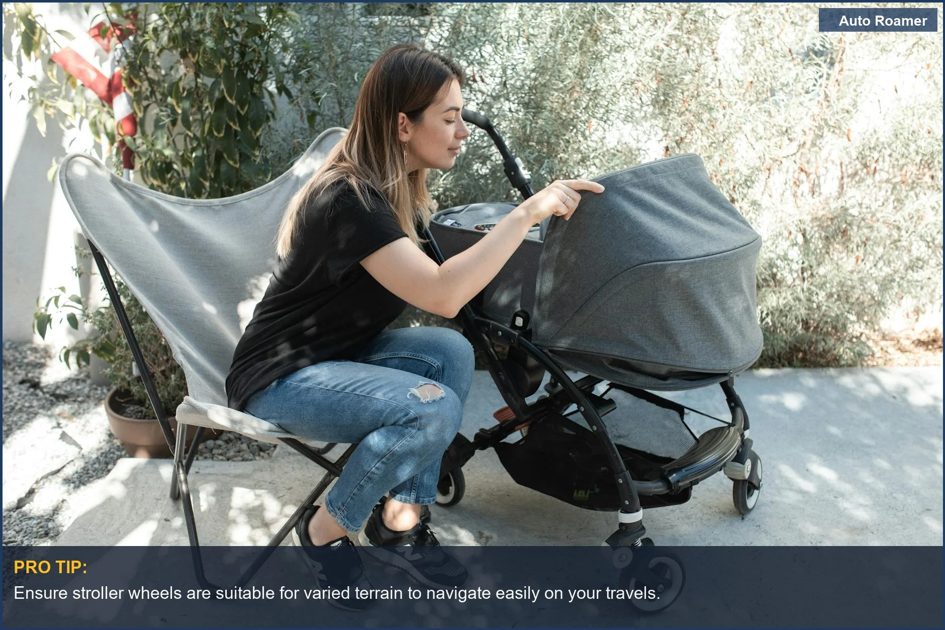Young mother pushing a baby in a stroller outdoors, highlighting essential infant travel gear for sunny adventures.