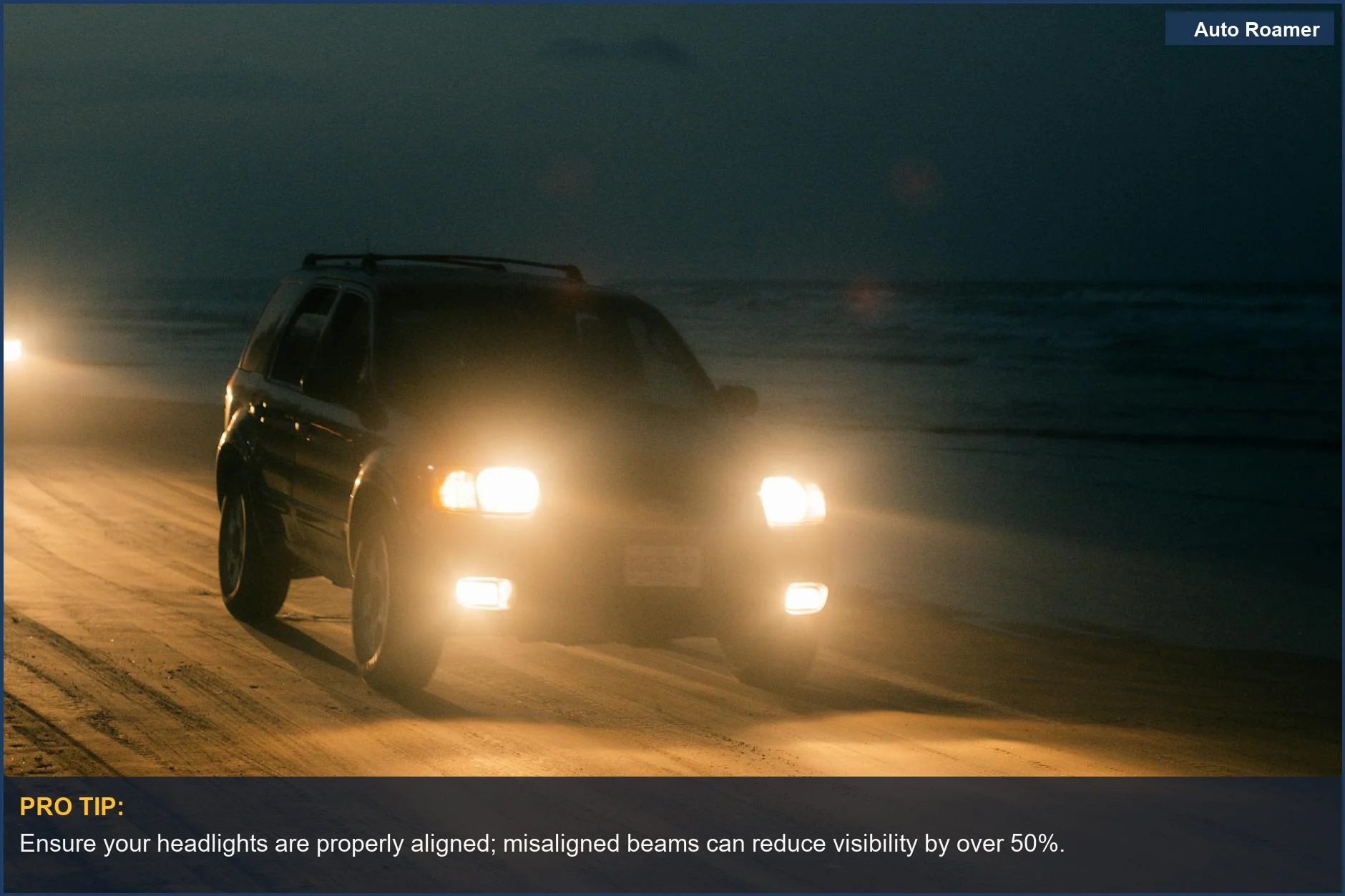 Black SUV headlights illuminate a dark beach road for safer night driving.