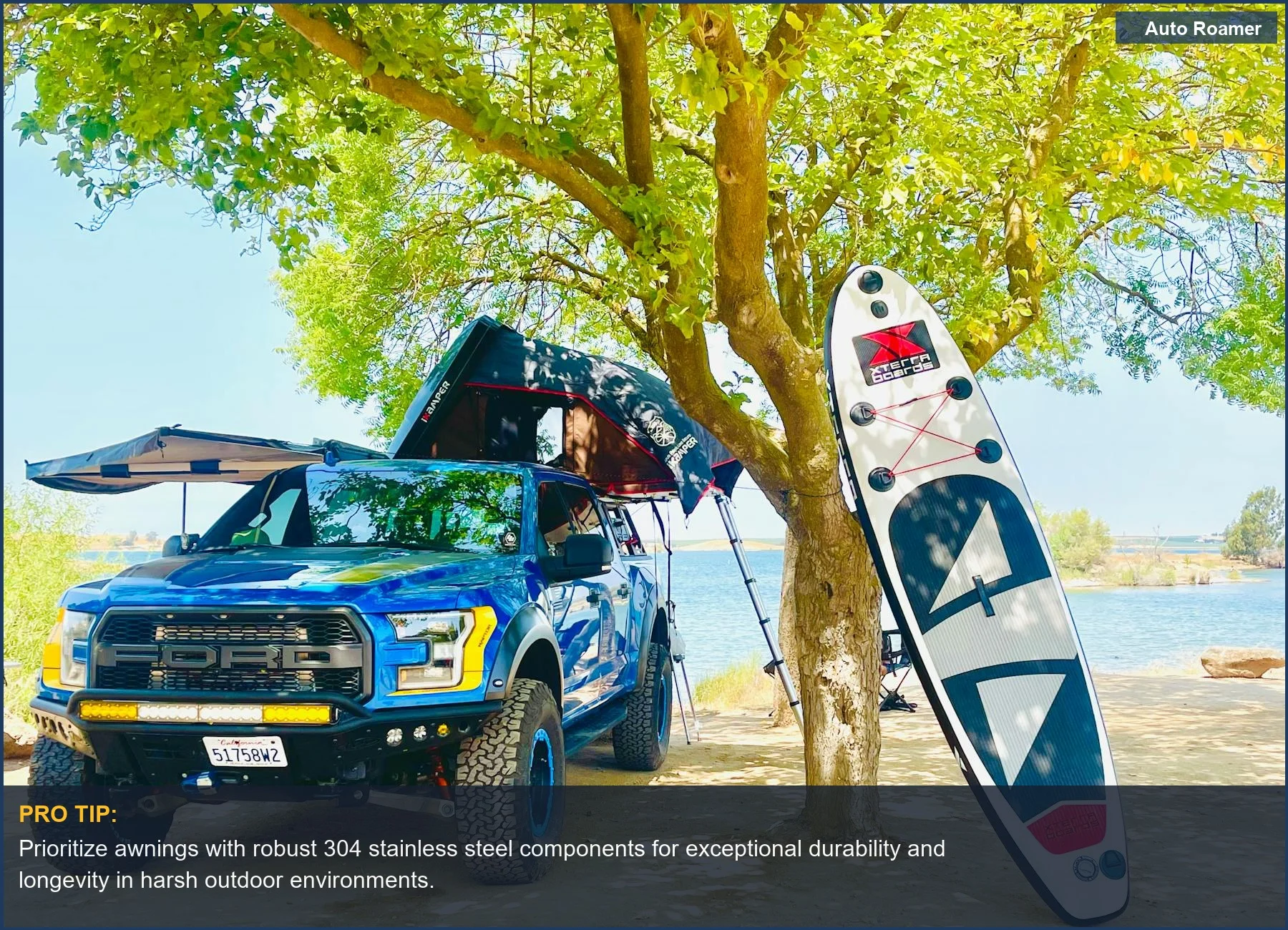 Enjoy lakeside adventures with an off-road truck, tent, and paddleboard, showcasing the best vehicle mounted awning for overlanding.