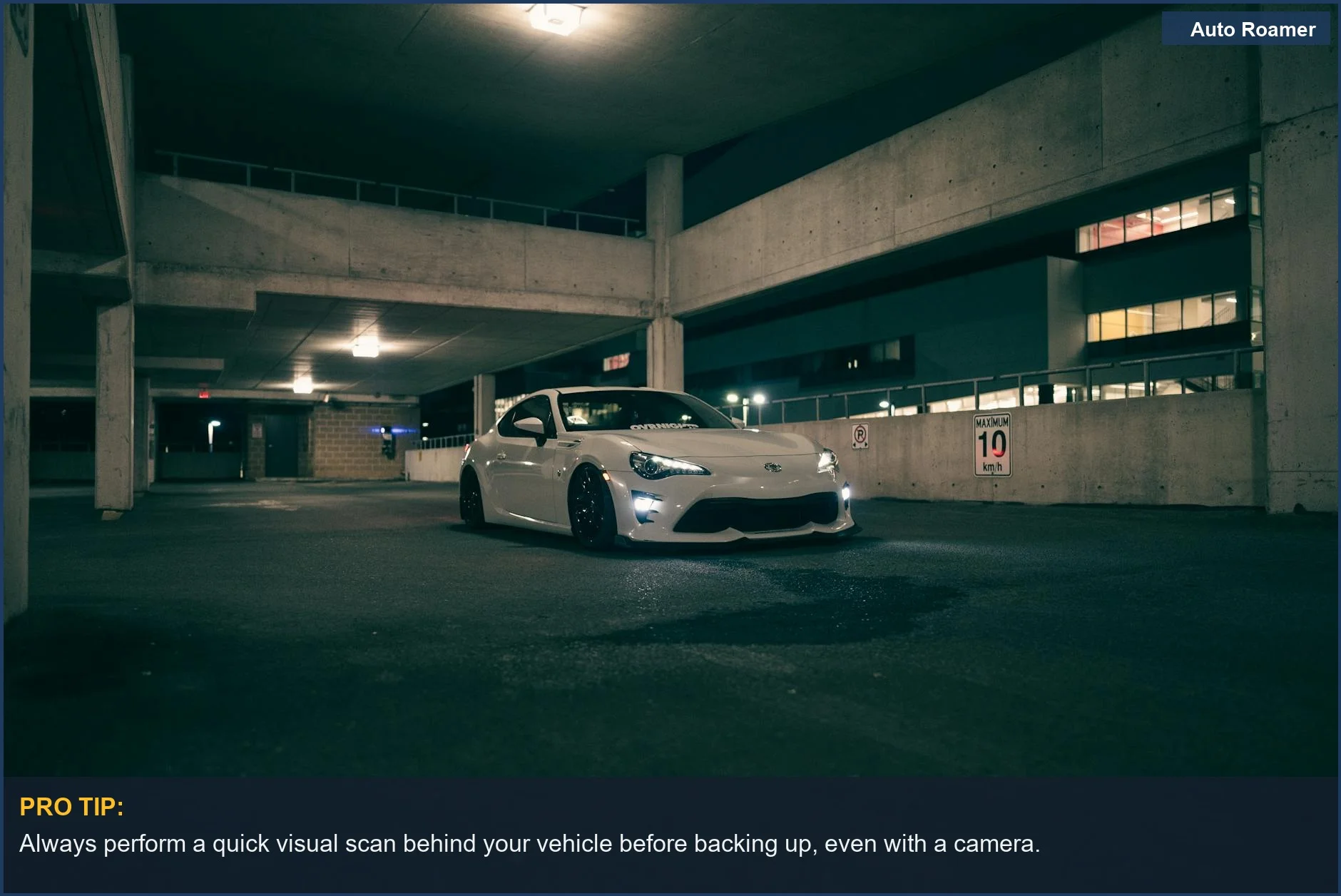 Stylish white sports car in a dimly lit urban garage at night, showing backup camera challenges.