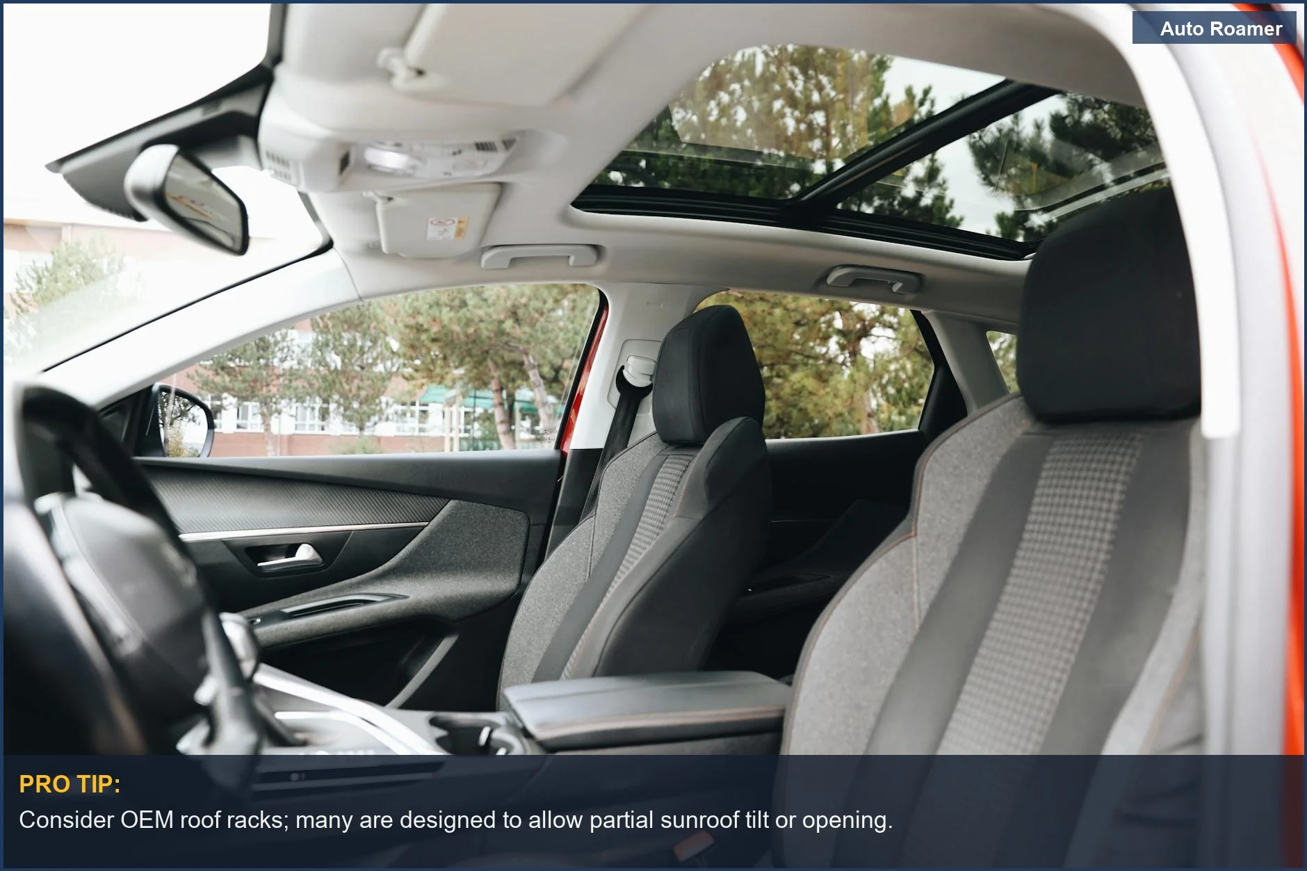 Modern car interior featuring a panoramic sunroof and front seats, crucial for roof rack installation.