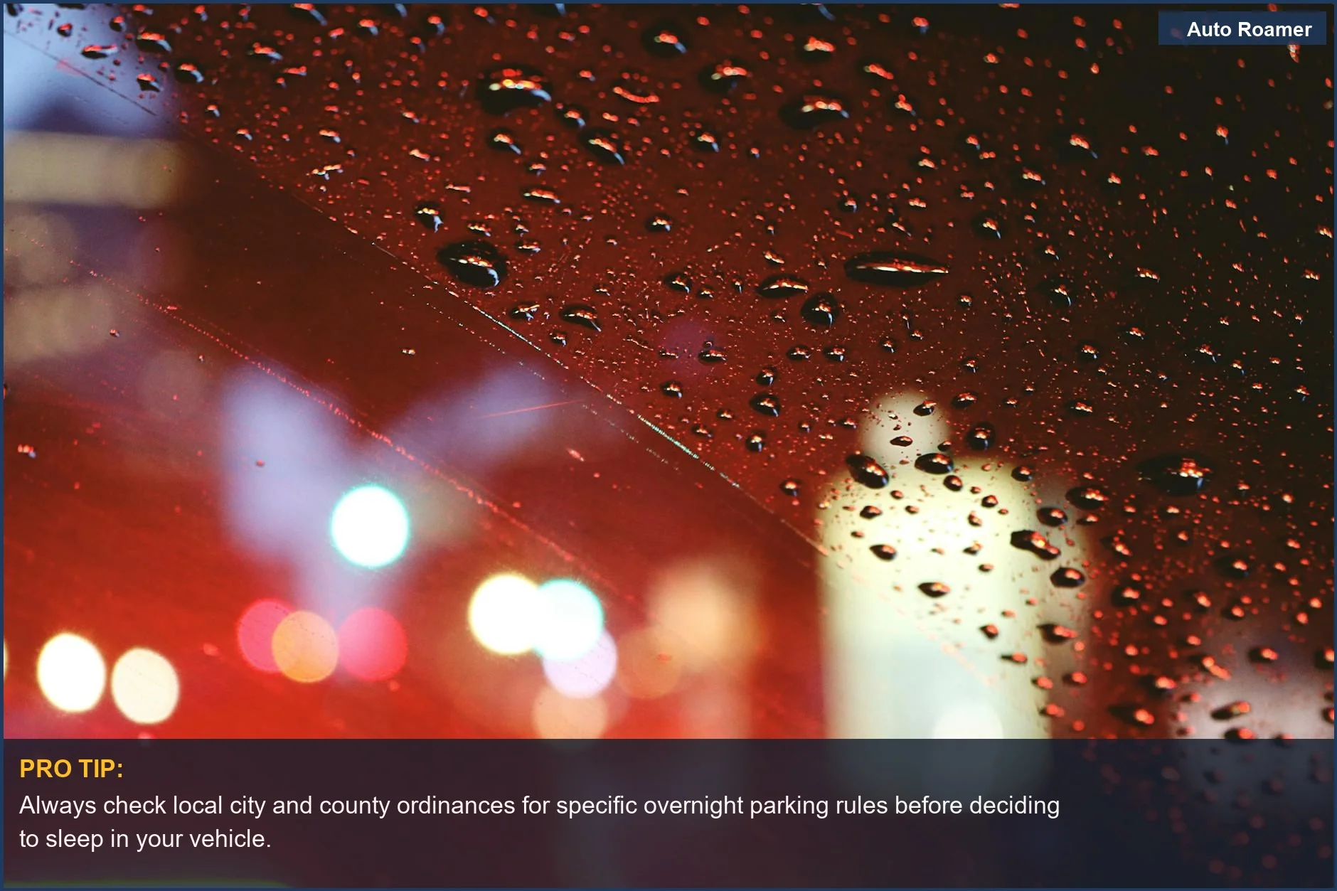 Blurred city lights through a rainy car window at night, suggesting a traveler contemplating where it's legal to sleep in a car.