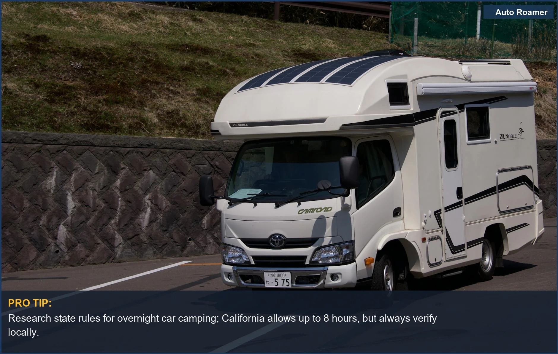 Sleek white camper van parked roadside, illustrating overnight car camping possibilities.