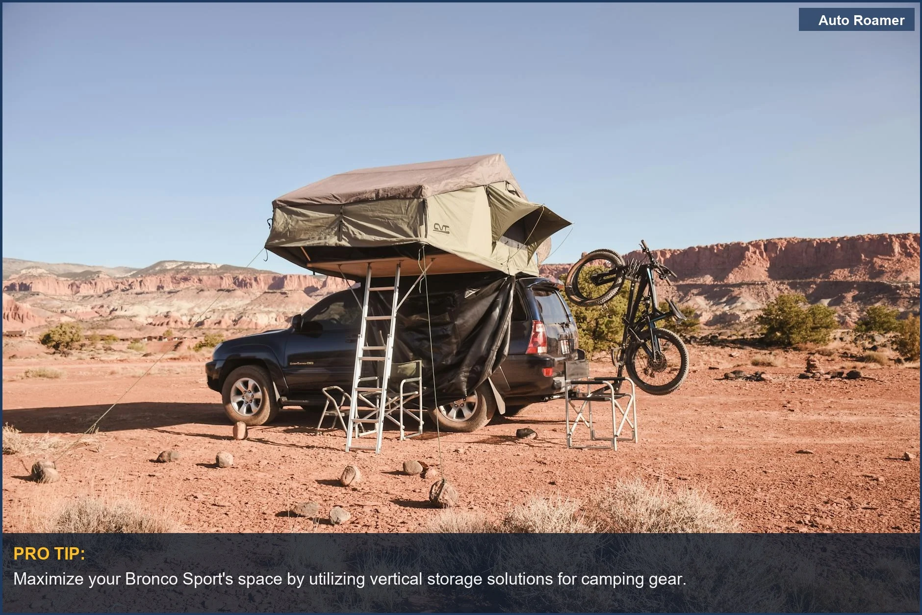 Ford Bronco Sport rooftop tent setup with mountain bike for desert camping.