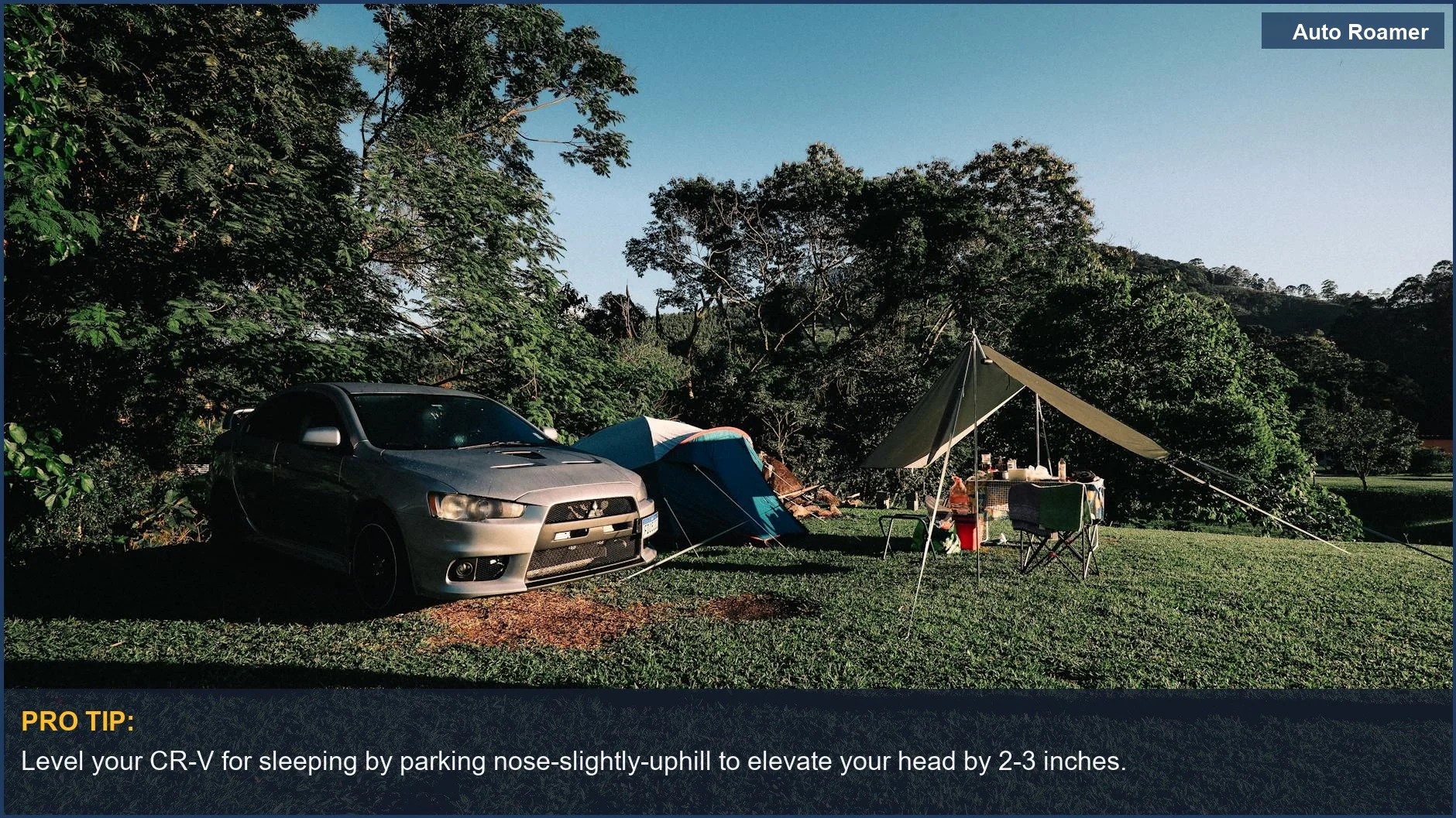 Peaceful car camping with a leveled CR-V and tent in lush greenery.