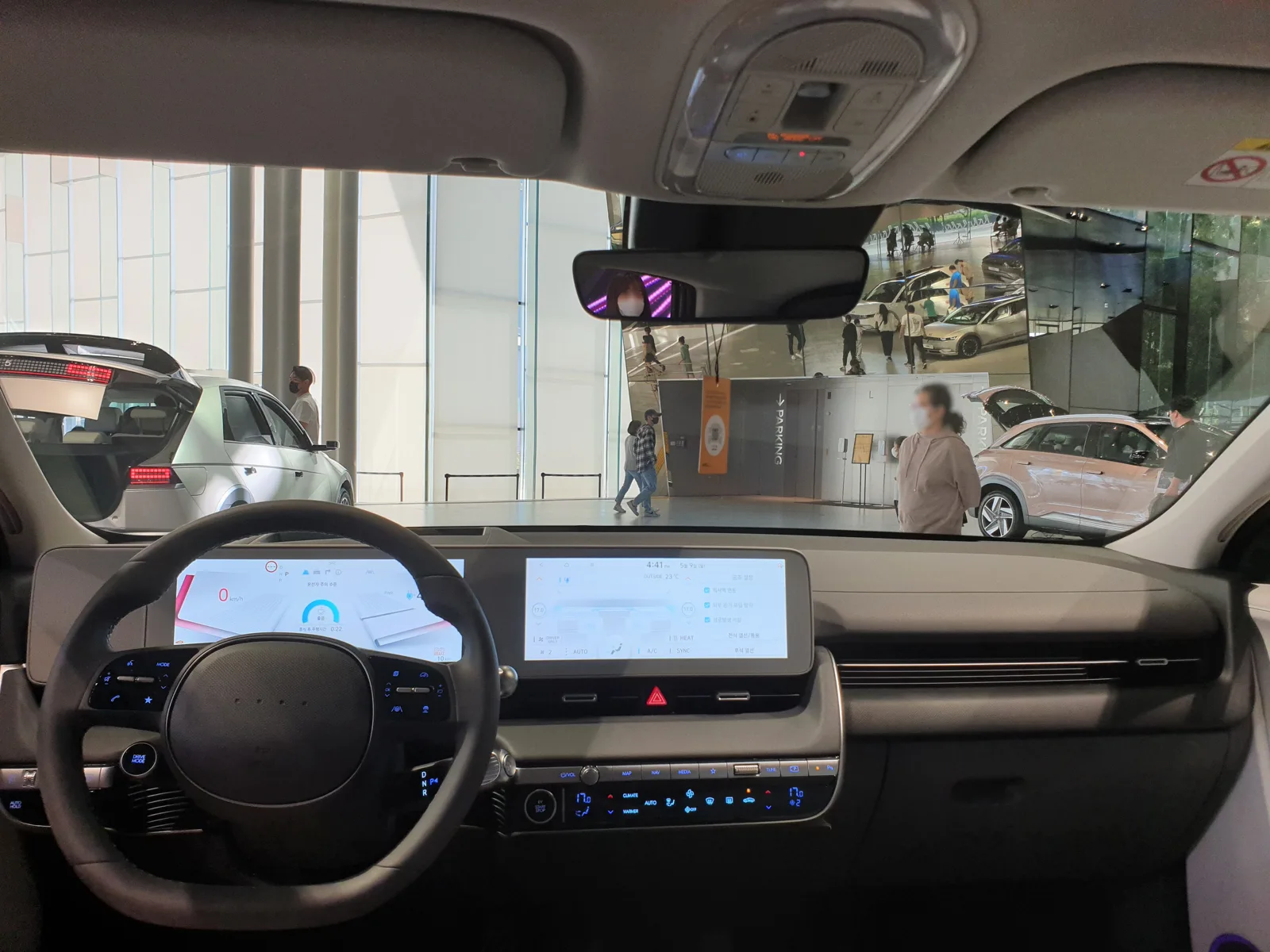 The dashboard and twin screens inside a Hyundai Ioniq 5, the cabin you sleep in on a car-camping night