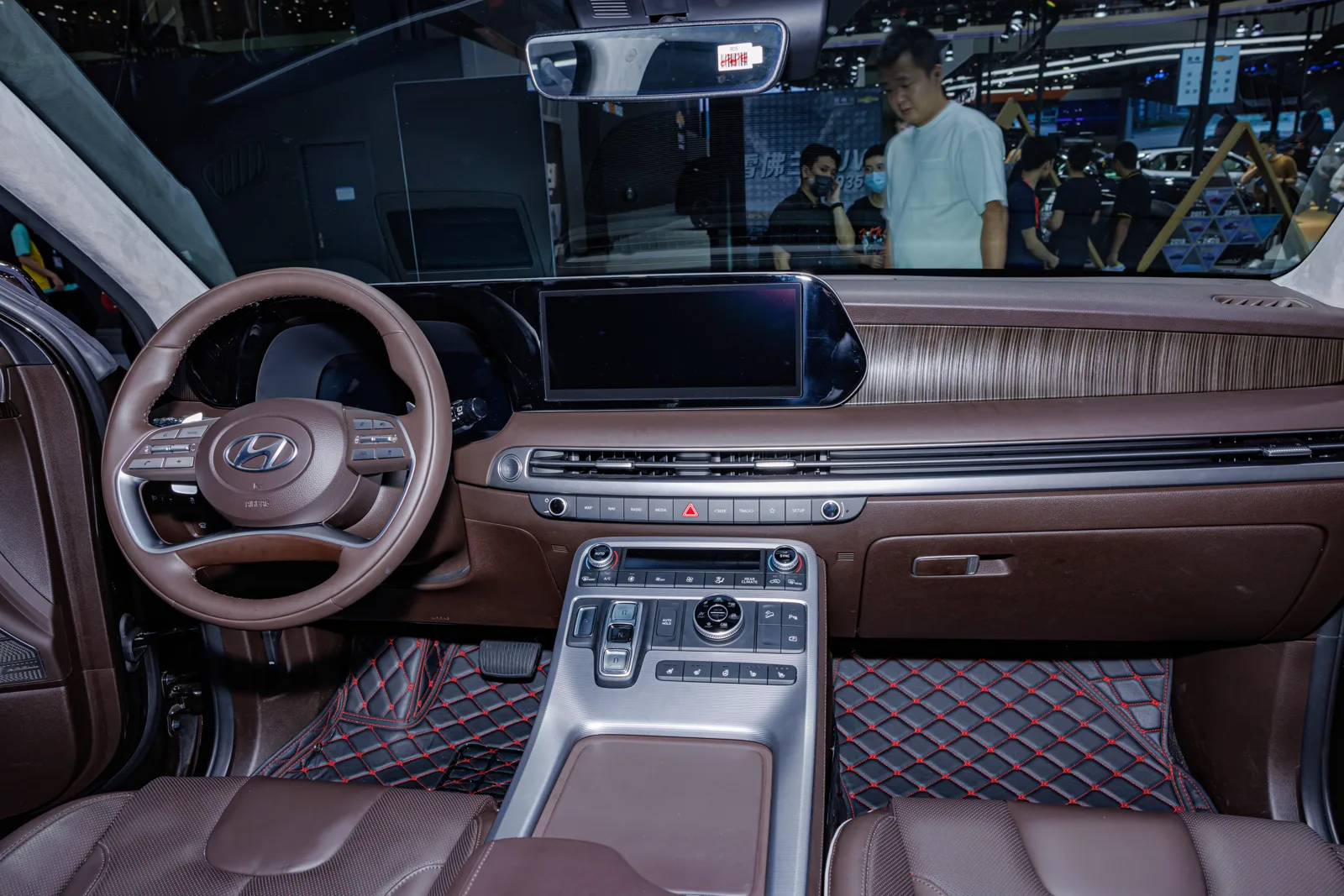 The brown two-tone cabin and dashboard of a Hyundai Palisade, the interior you sleep inside