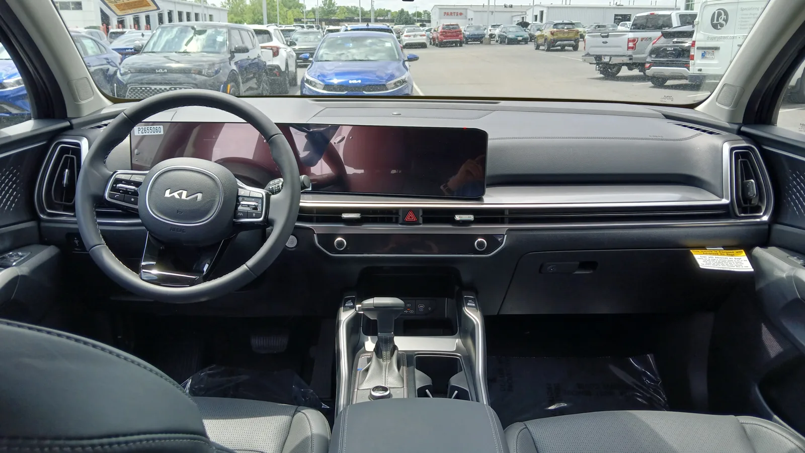 The dashboard and console inside a 2024 Kia Sorento, the cabin you sleep in when car camping