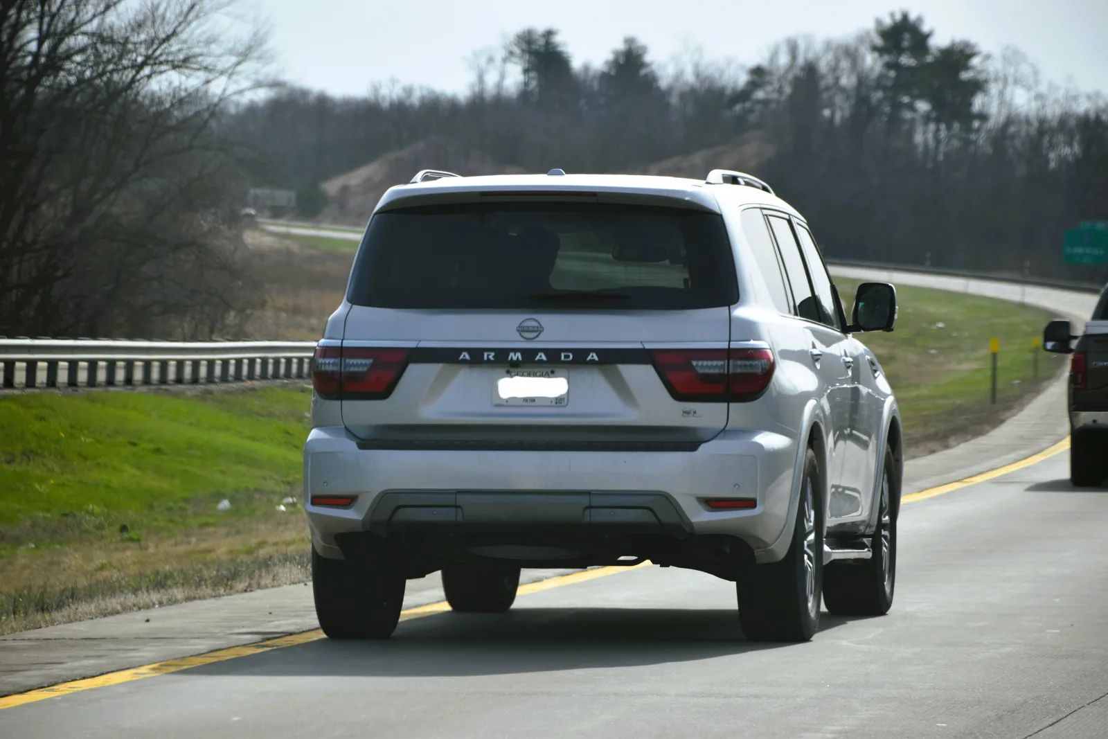 A silver pre-2025 Nissan Armada full-size SUV, the earlier generation this sleeping guide compares
