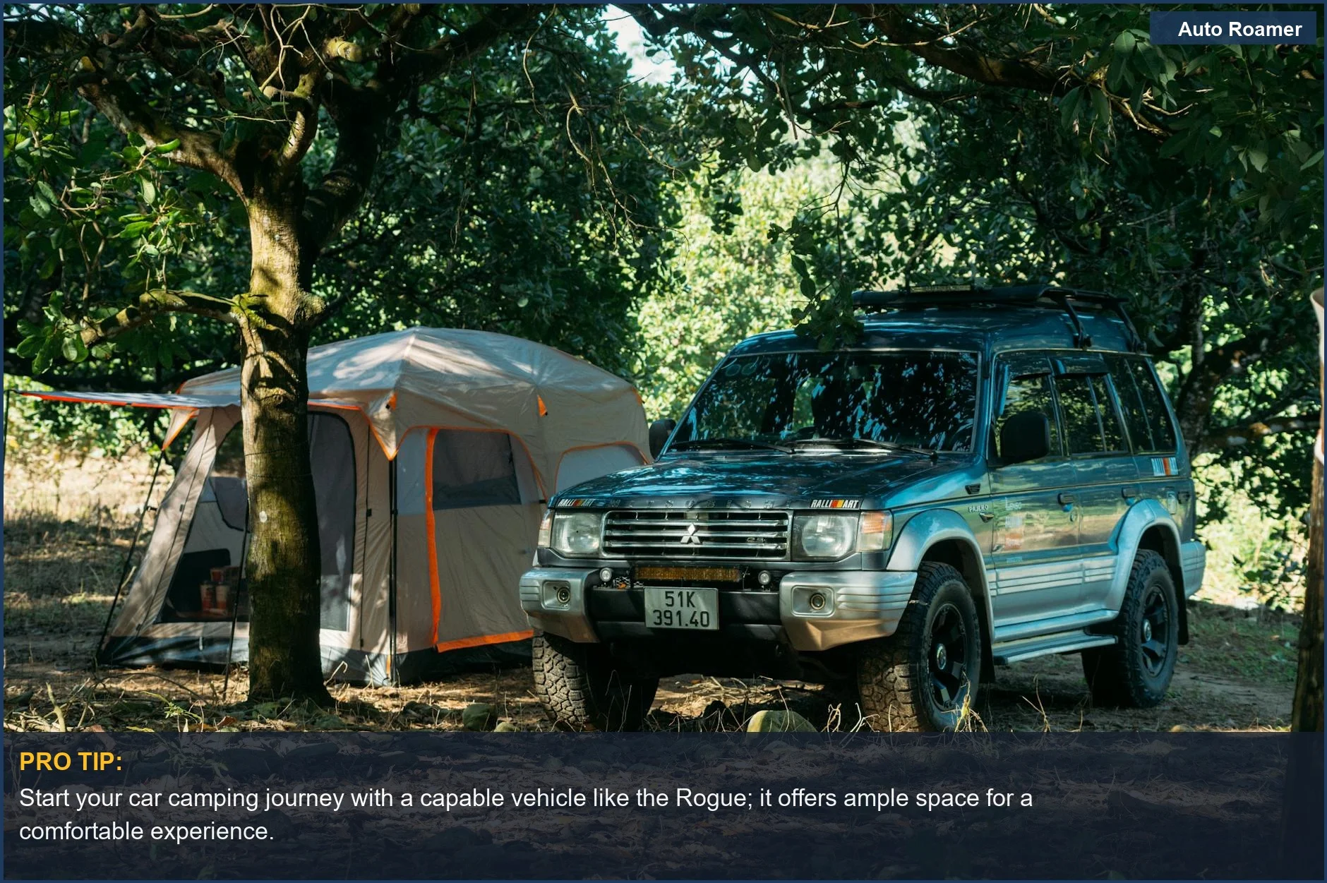 Nissan Rogue SUV parked next to a tent in a forest, for outdoor enthusiasts.