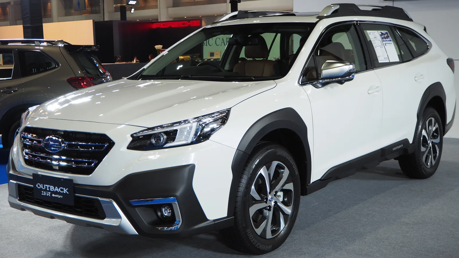 A white Subaru Outback wagon shown side-on, the car this guide measures for sleeping two adults