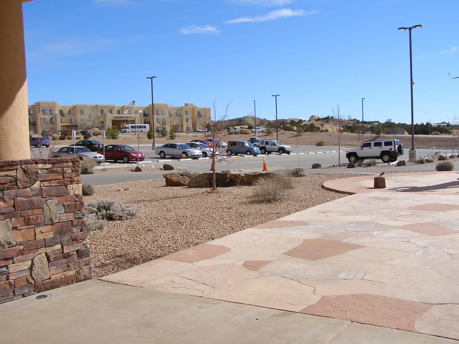 A casino resort parking lot with cars and the resort building beyond, a lot where people sleep in a car
