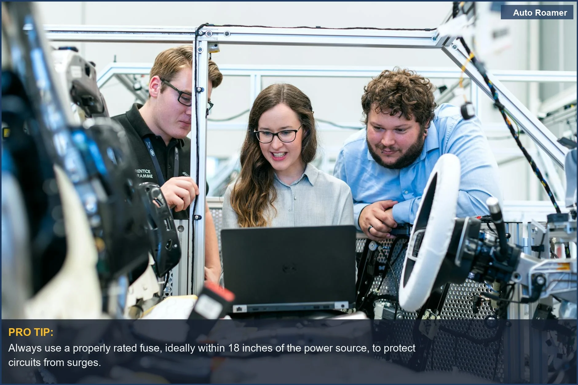 Automotive engineers collaborating on a car project, highlighting common car accessory installation mistakes and electrical system risks.
