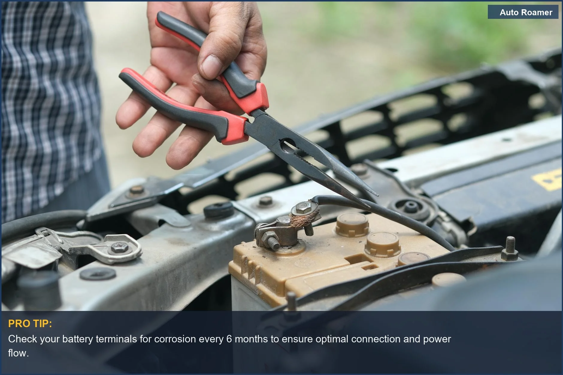 Person inspecting a car battery with pliers, illustrating the direct impact of dash cam parking mode battery drain.