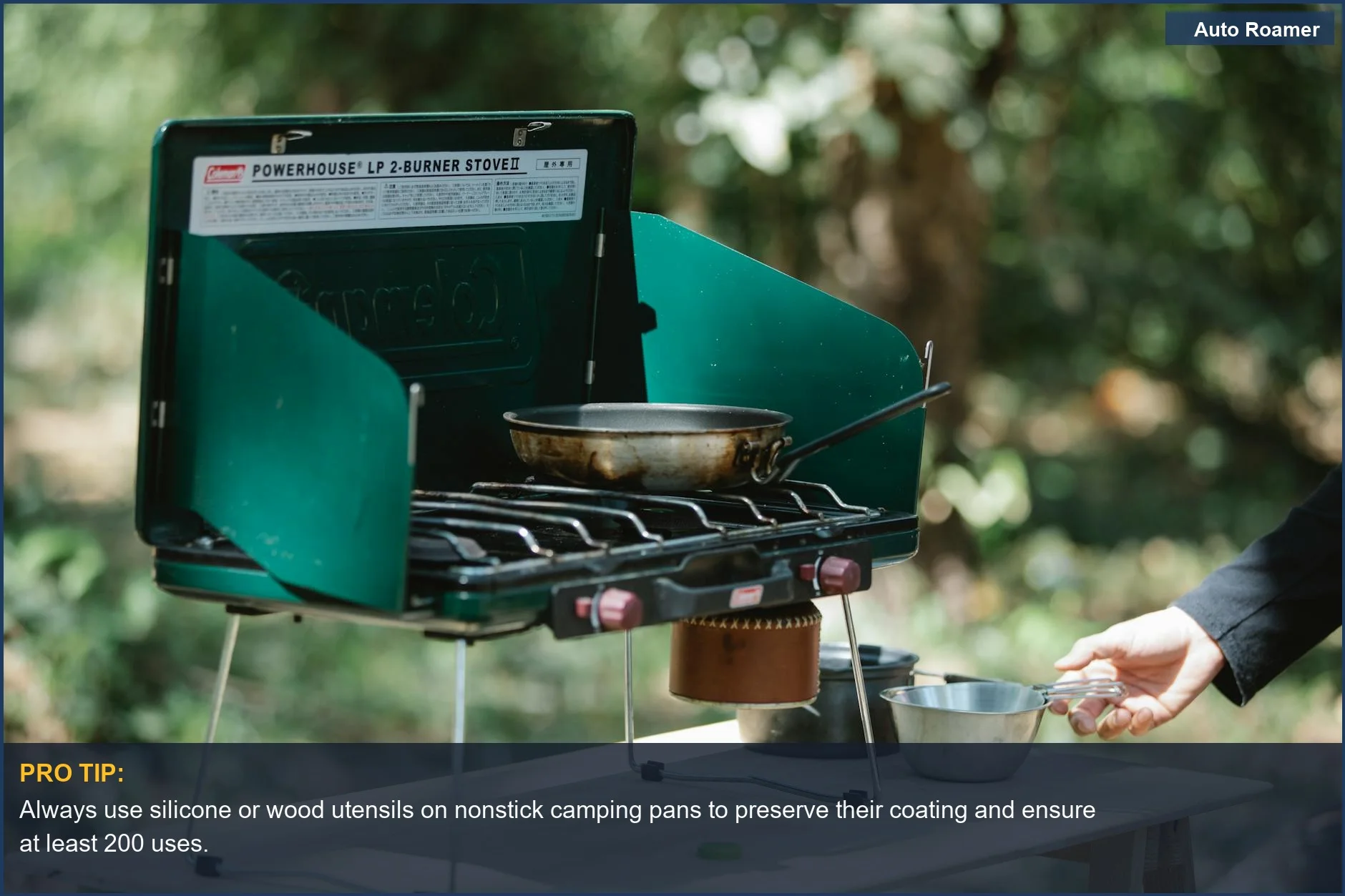 Portable gas stove with nonstick camping pans and cooking equipment for efficient outdoor meals.