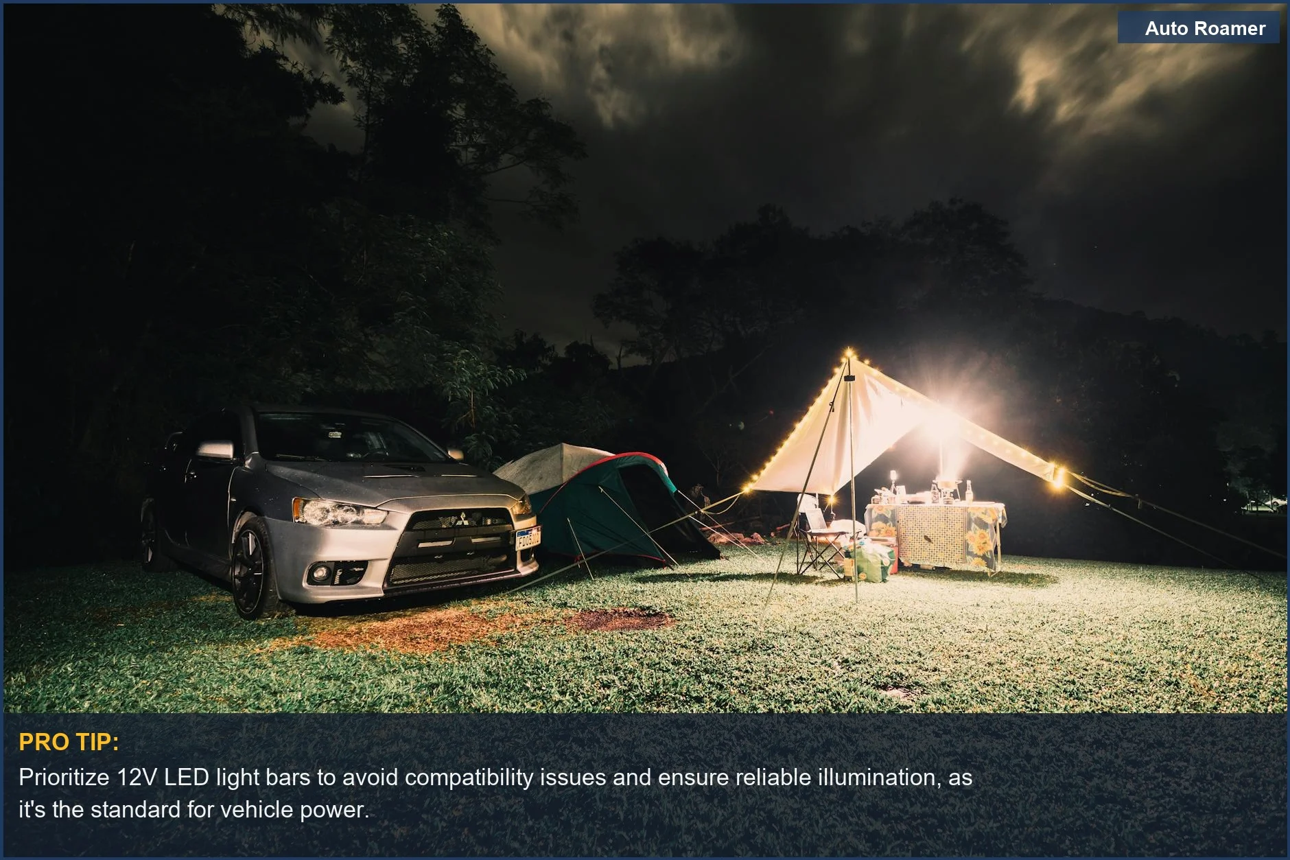 Serene camping site at night with illuminated tents and car, highlighting the common 12V vehicle power system for LED bars.