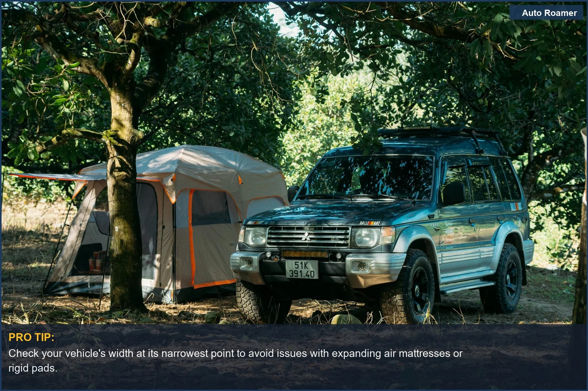 An SUV parked in a forest, ready for adventure, with a tent nearby for sleeping.