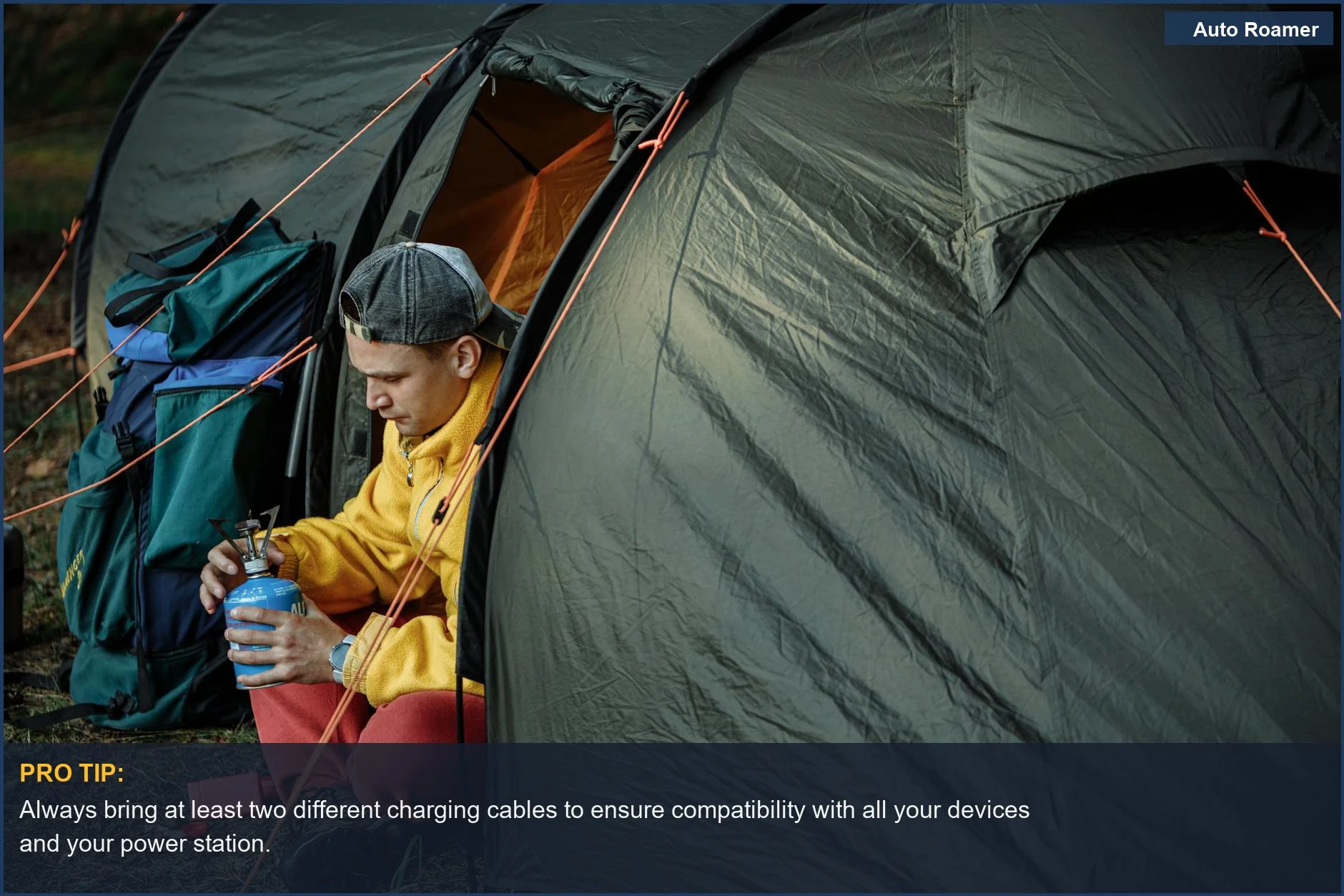 Camper setting up a stove near a tent, illustrating the essential power station accessories needed for outdoor adventures.