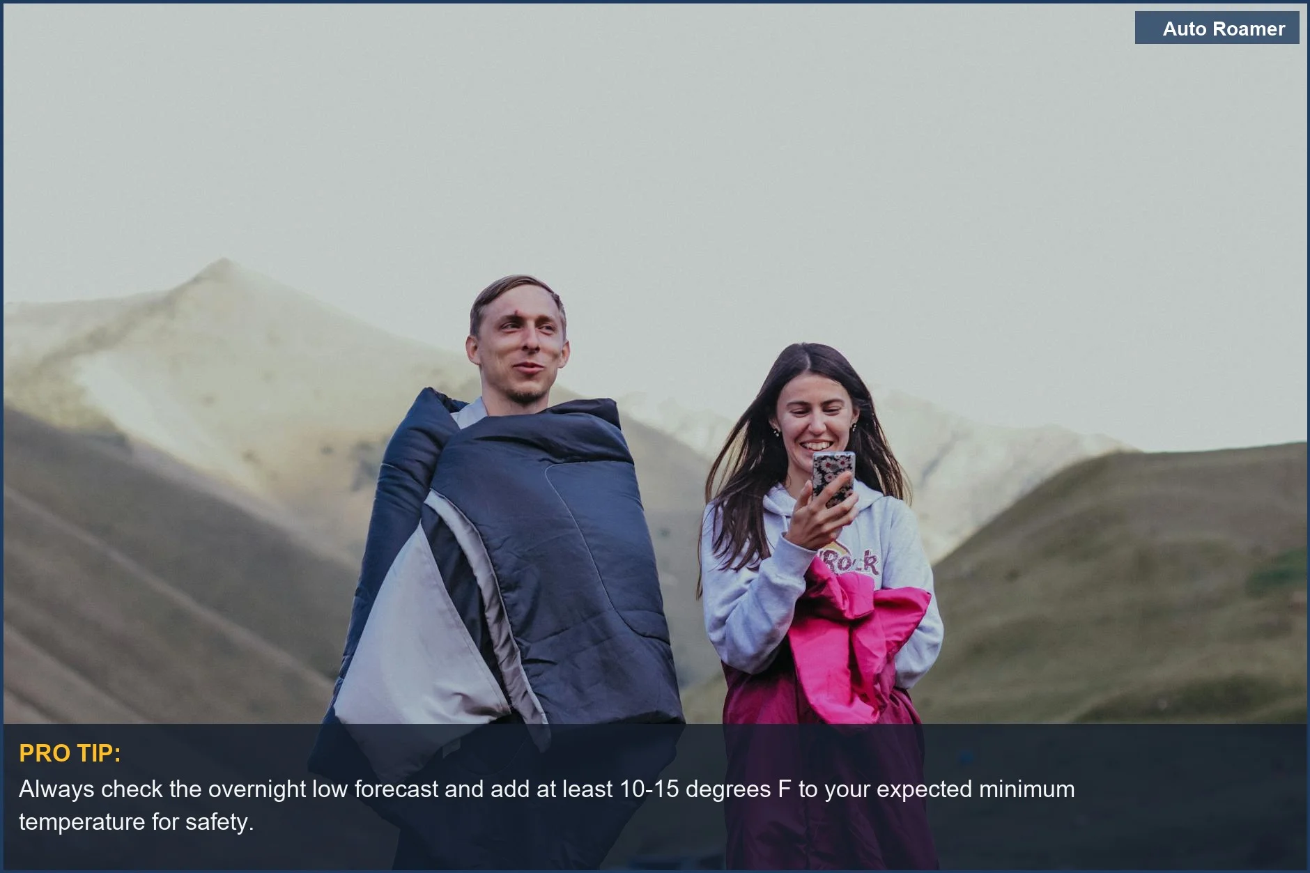 Couple enjoying a mountainous landscape wrapped in sleeping bags, highlighting the need for appropriate sleeping bag temperature ratings.