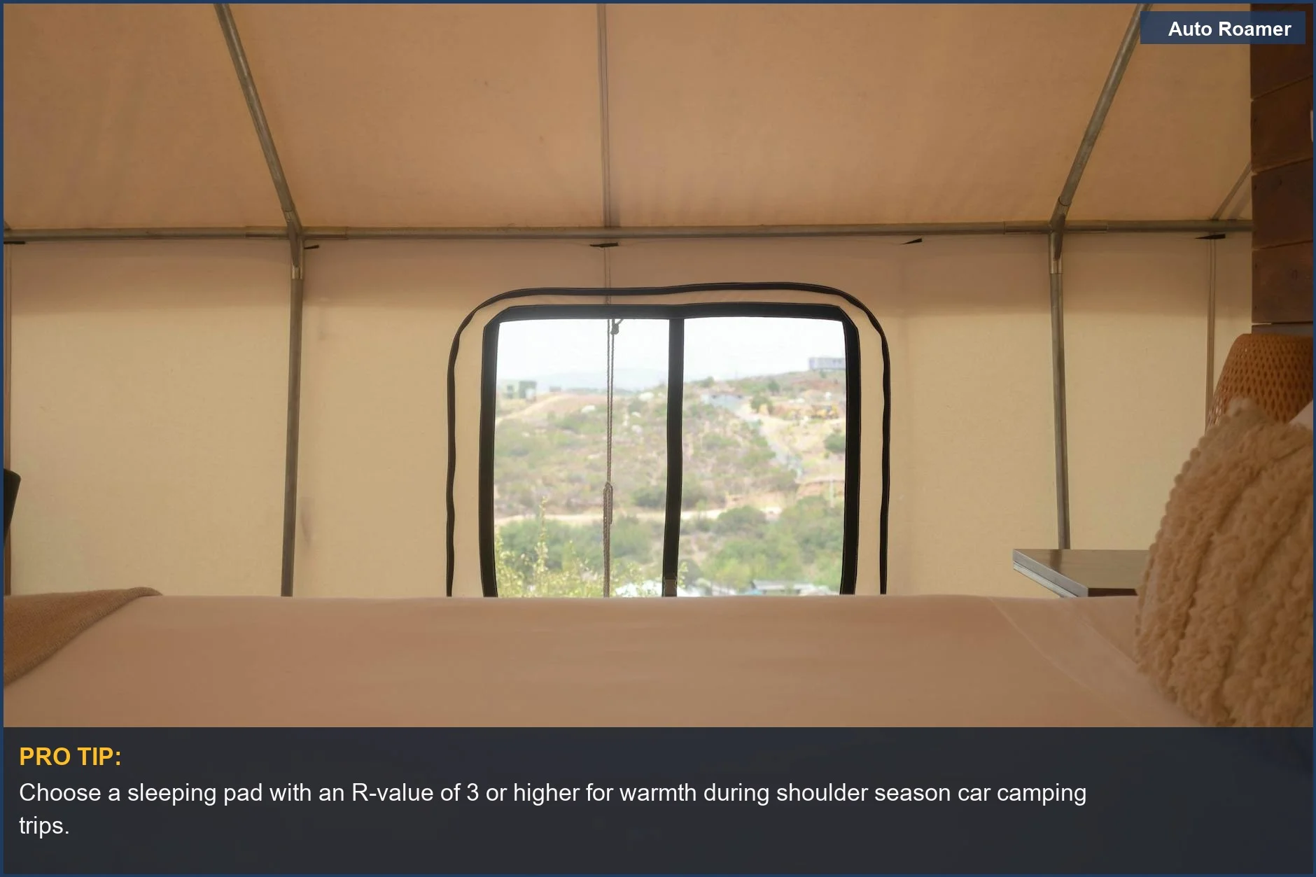 Relaxing tent interior with a sleeping pad and a scenic landscape view, ideal for car camping.