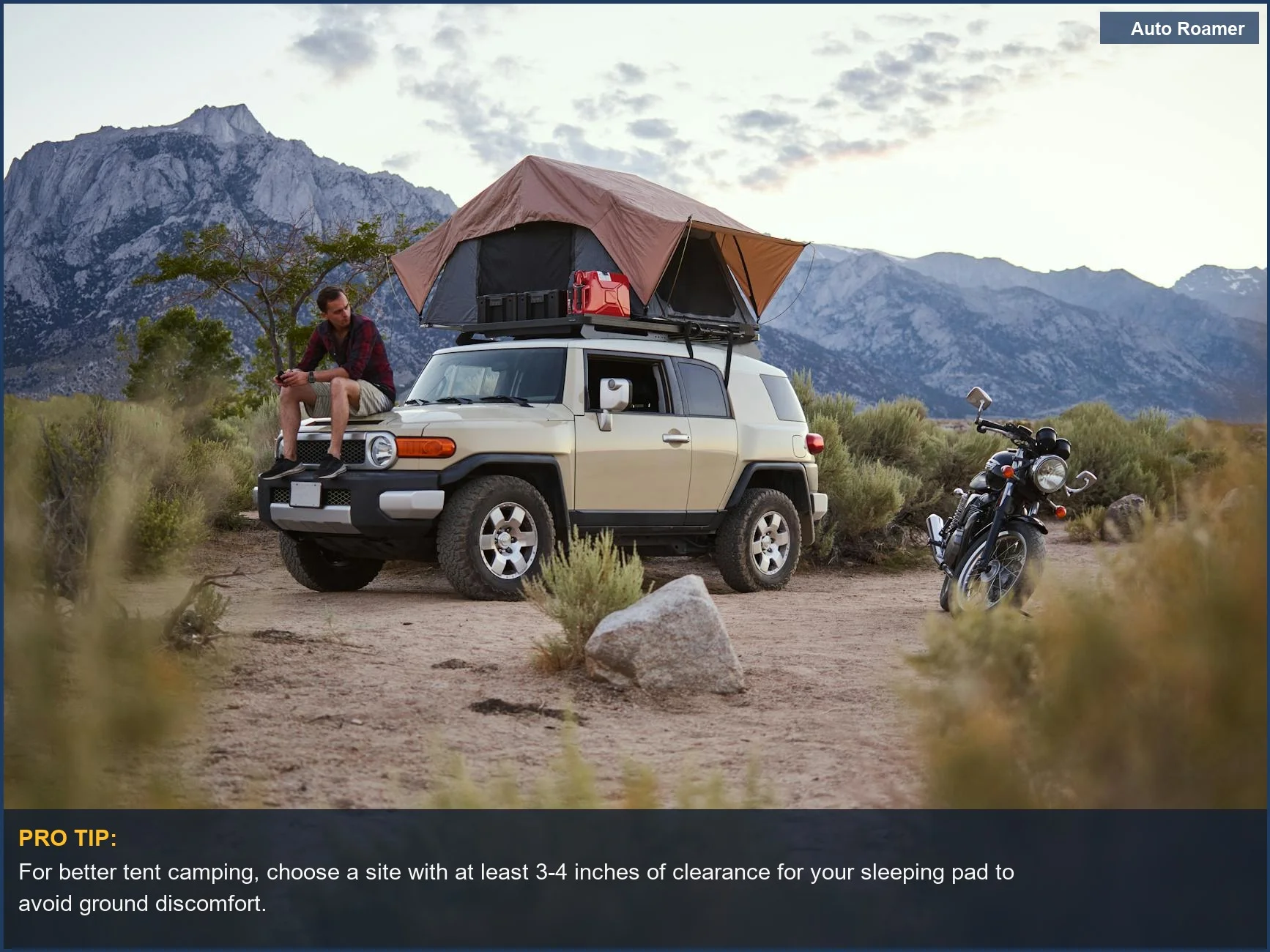 Man enjoying tent camping relaxation beside a car with rooftop tent and mountain backdrop.