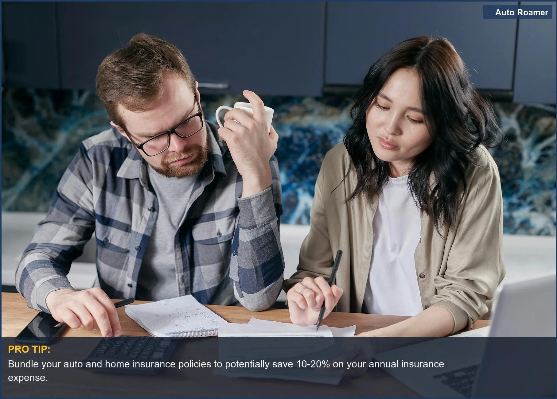 Pareja revisando facturas del hogar y presupuesto con calculadora en la mesa de la cocina, discutiendo los costes del seguro de coche.