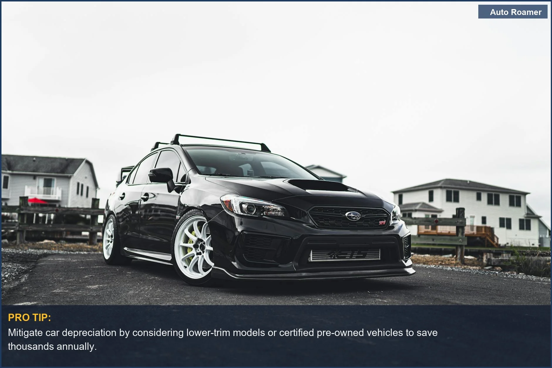 Stylish black sports car parked on a suburban driveway, illustrating how fast cars lose value.
