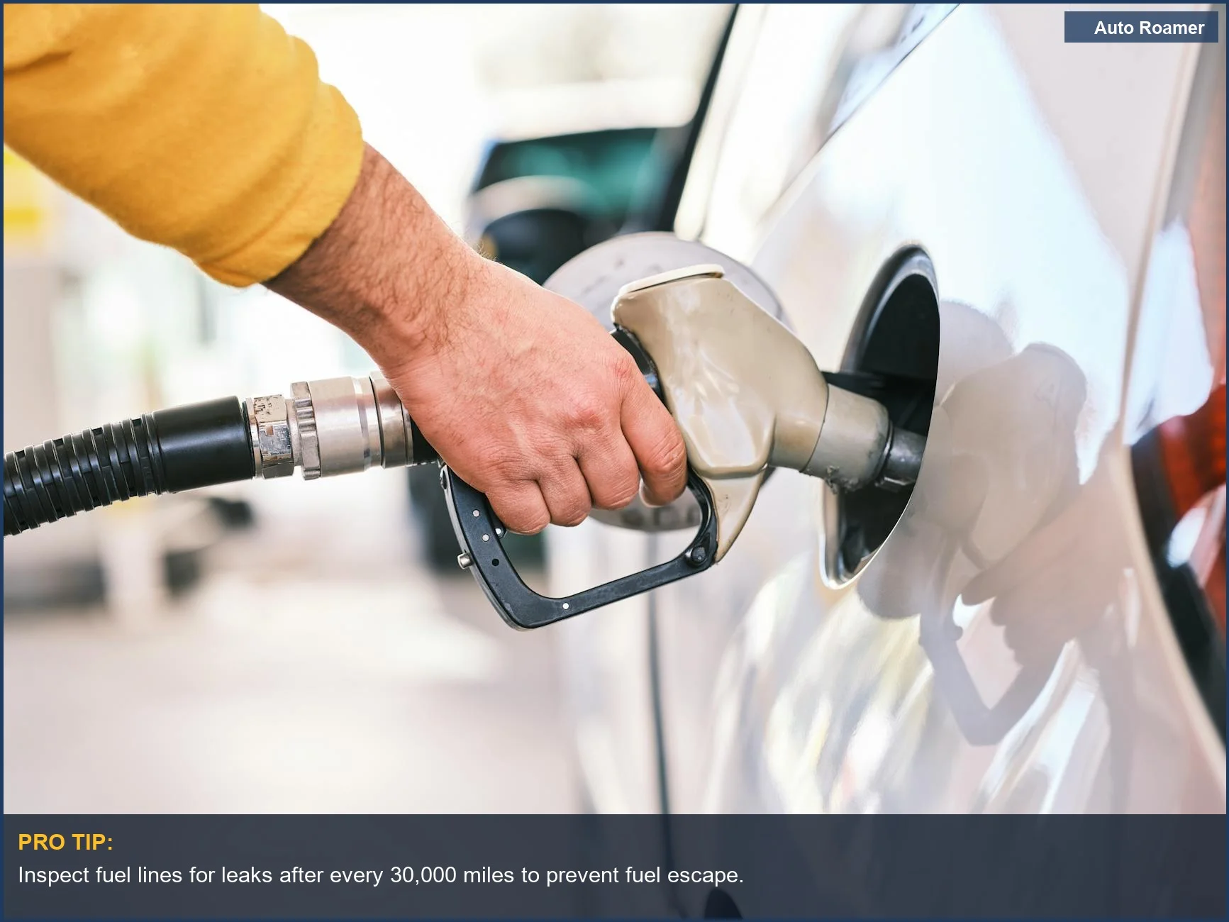Person refueling a car at a gas station nozzle, a common cause of lingering gas smells.