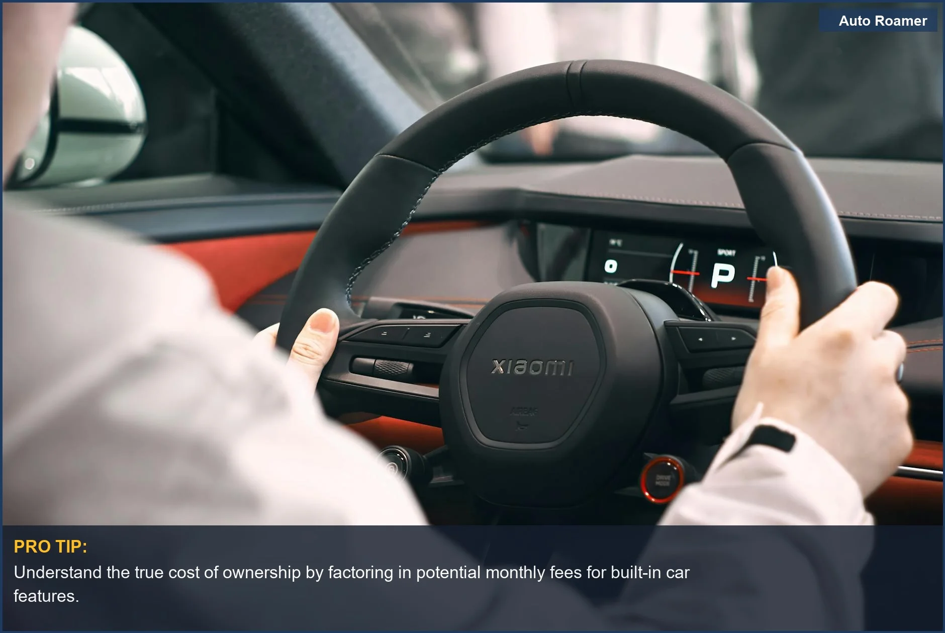 Person's hands on a modern car steering wheel, dashboard illuminated, highlighting car subscription paywall concerns.