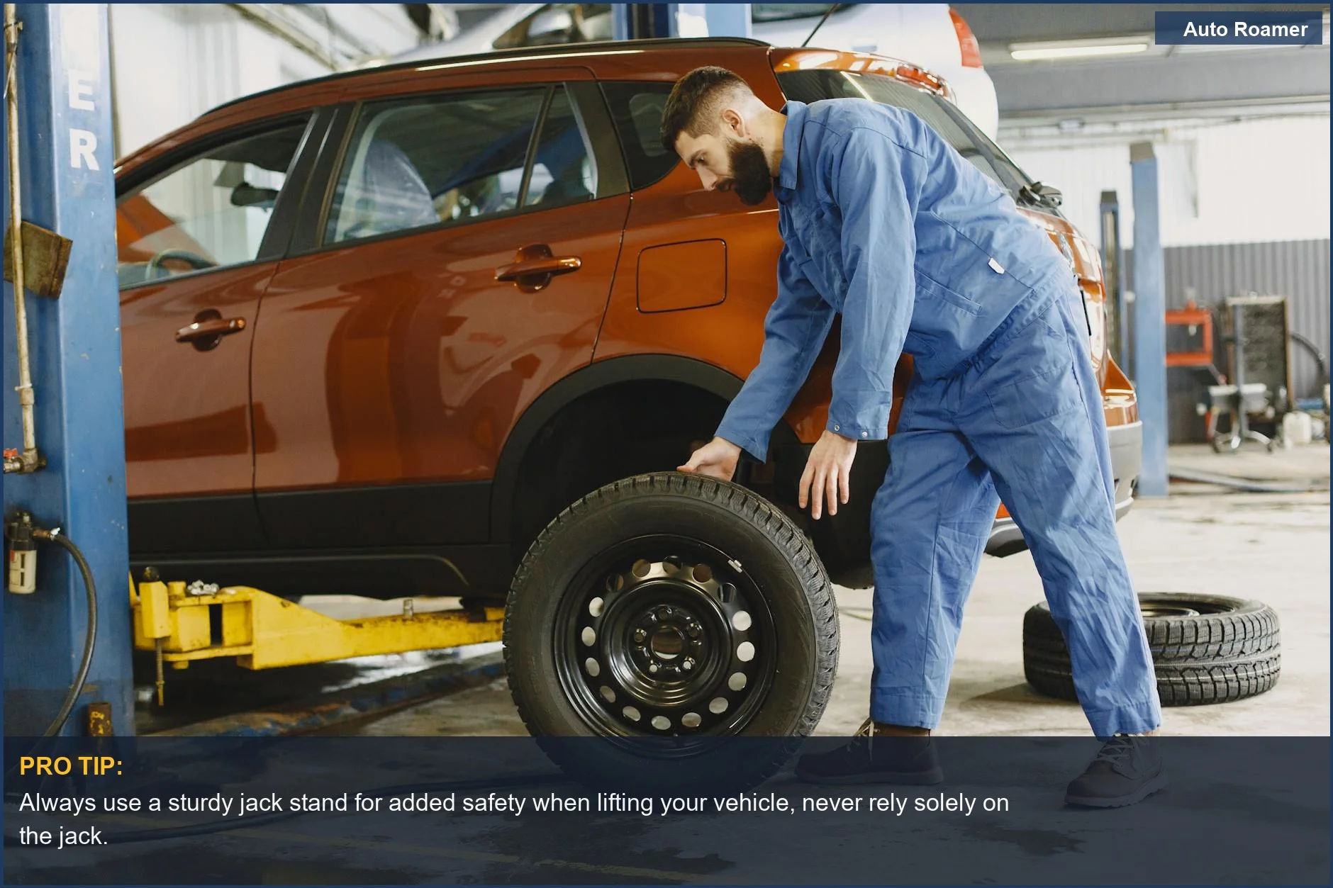 Expert mechanic safely changes a flat tire on a red SUV in a well-lit garage.