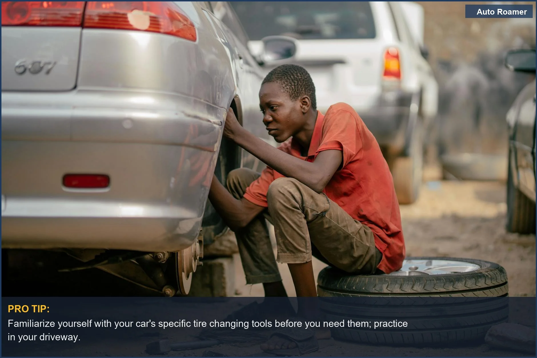 Young mechanic focused on repairing a car tire, highlighting the importance of proper tool usage.