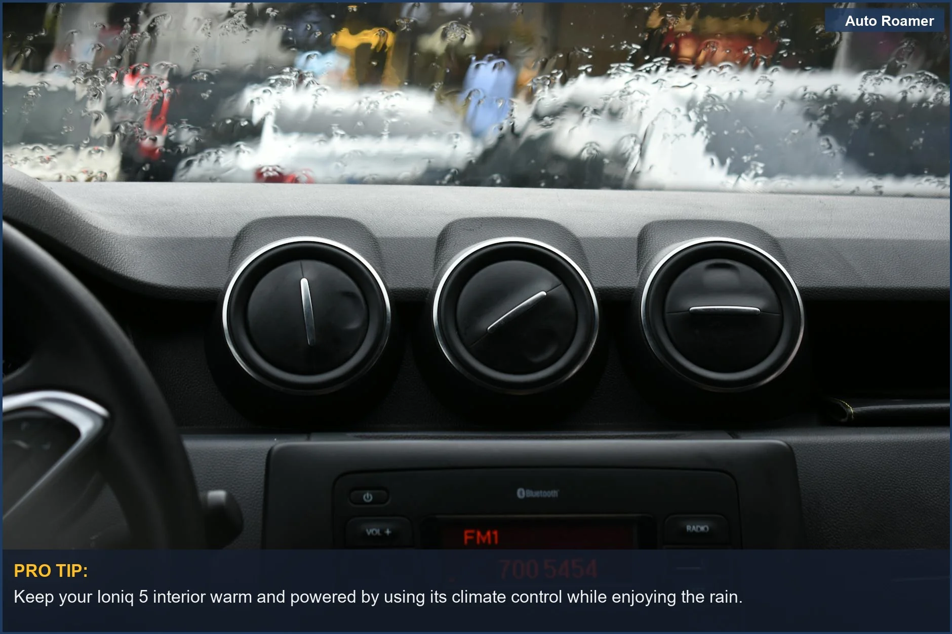 Cozy Ioniq 5 dashboard view through a rainy windshield, highlighting vehicle power for camping.