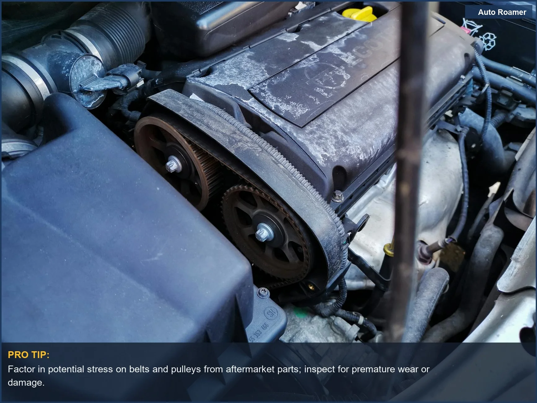 Close-up of car engine belts and components under the hood, vital for understanding previous gear modifications.