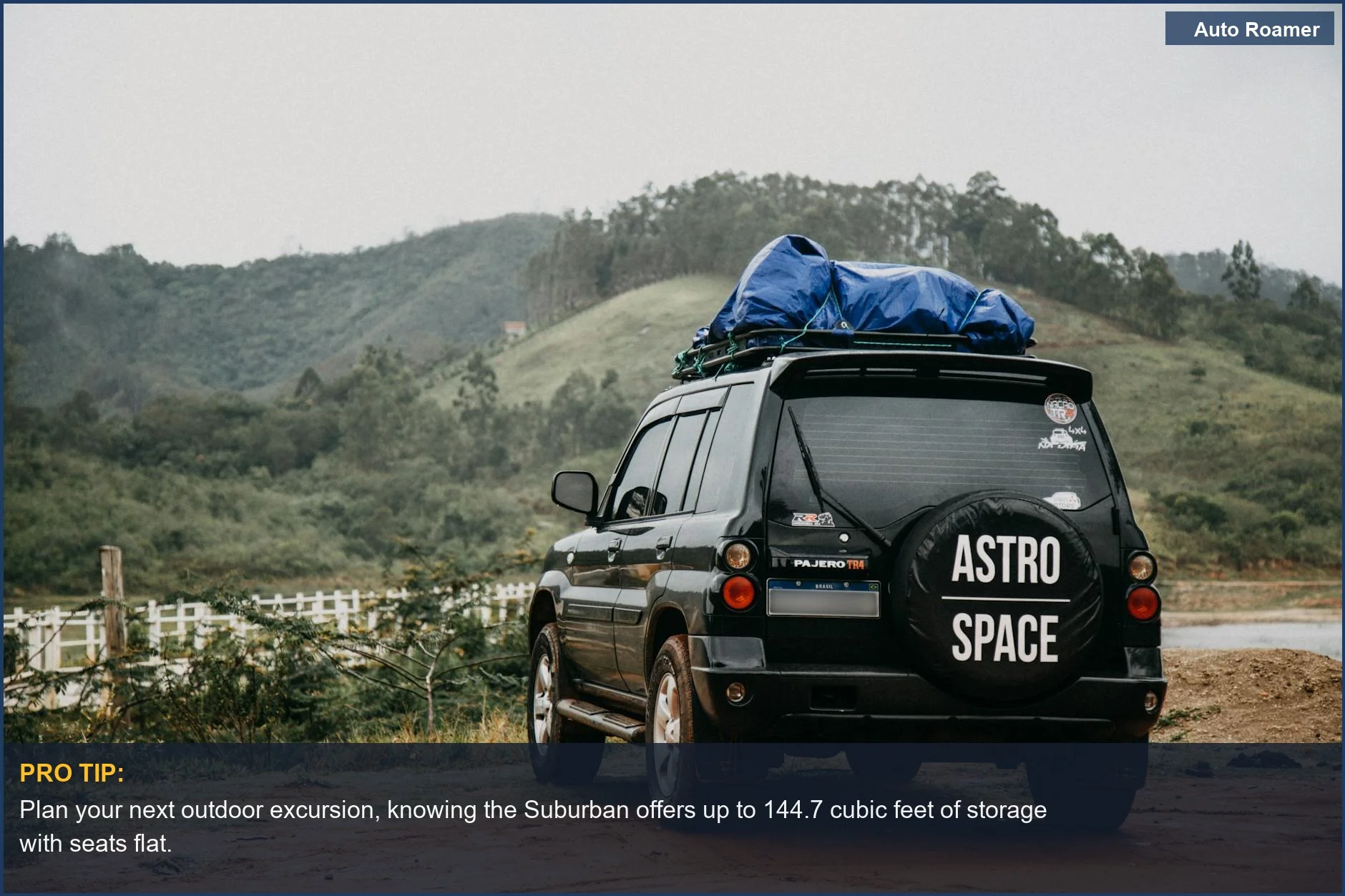 Black Chevrolet Suburban with roof rack, showcasing ample cargo capacity with seats down.