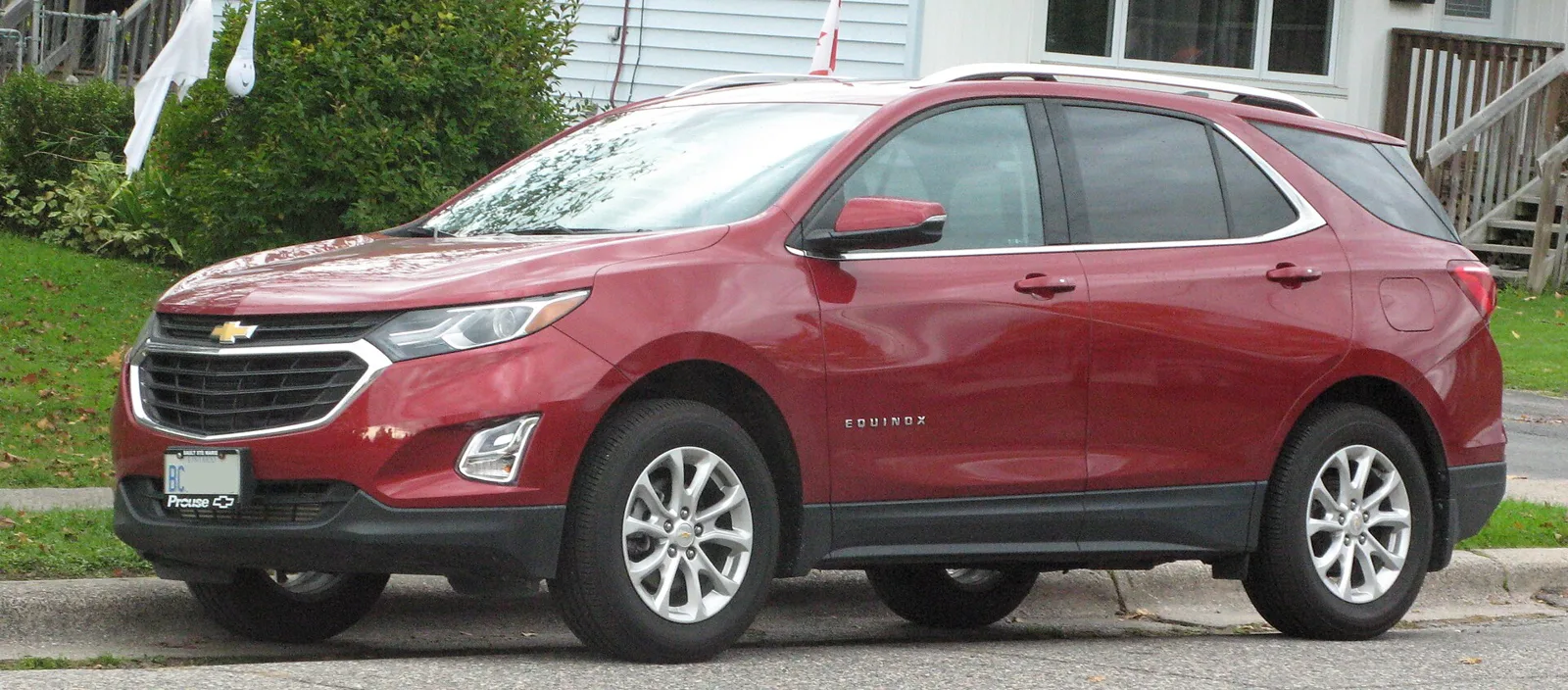 Red Chevrolet Equinox LT, current third generation, front three-quarter view with a chrome grille.