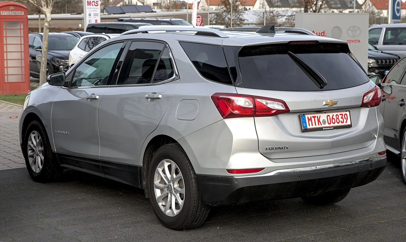 Silver Chevrolet Equinox, current third generation, rear three-quarter view.