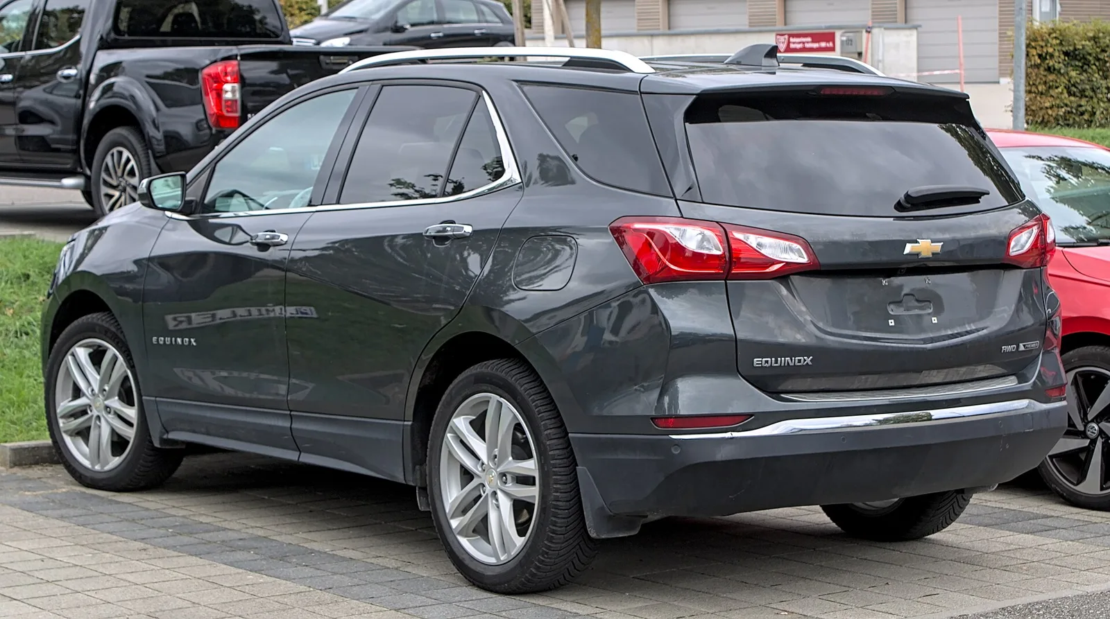 Gray Chevrolet Equinox, current third generation, rear three-quarter view showing the tailgate.