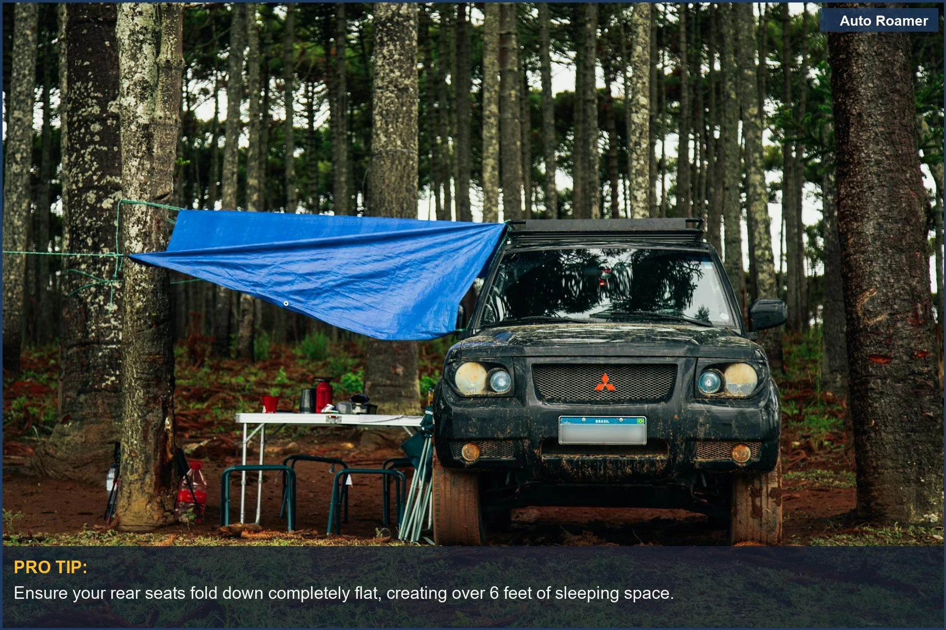 Rugged Chevy Trax SUV parked in a forest clearing, set up for car camping.