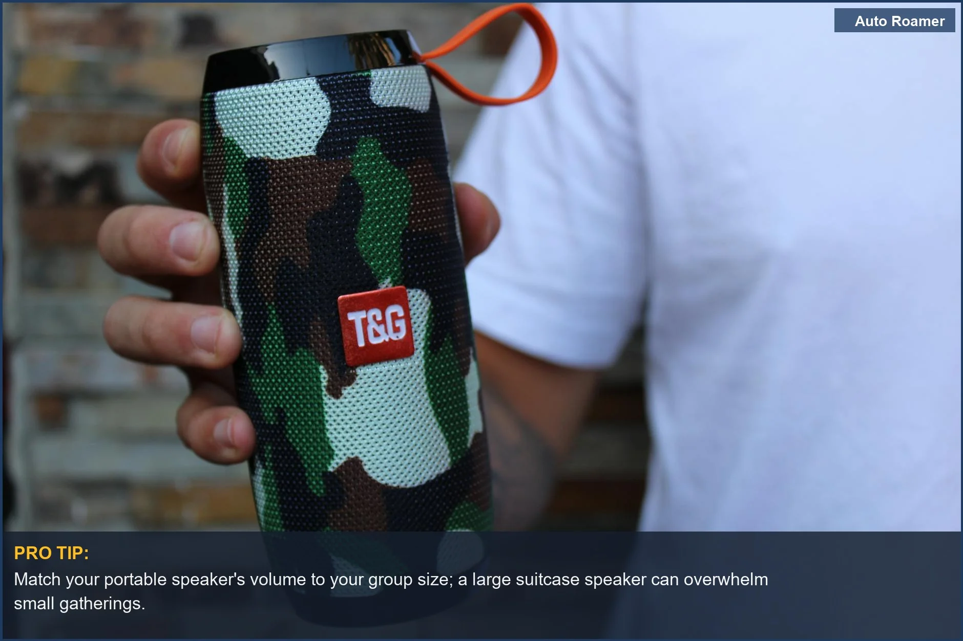 Close-up of a camouflage portable speaker held by a hand, showcasing rugged outdoor audio.