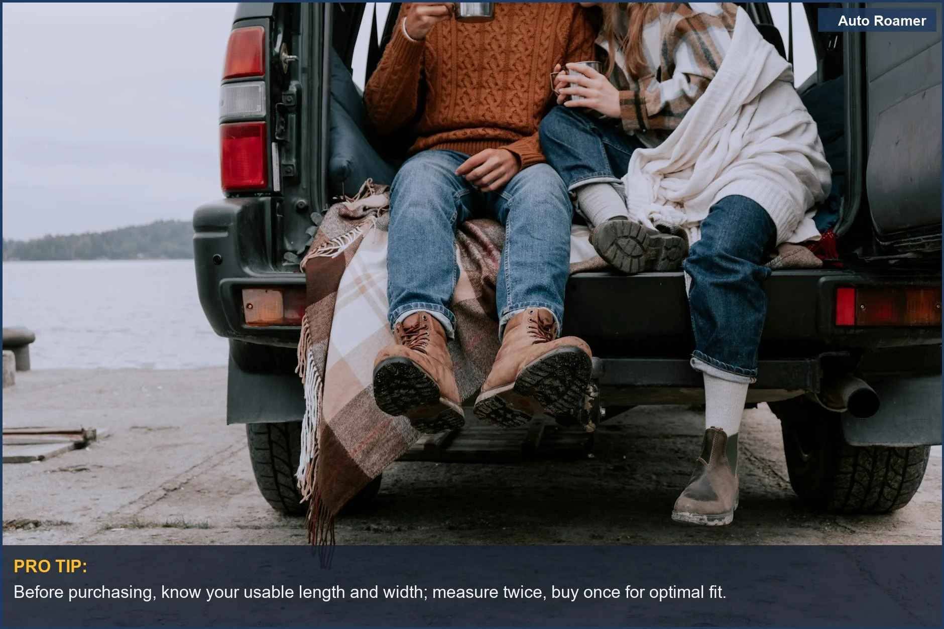 Couple enjoying drinks by a lake in an SUV trunk, demonstrating cozy car camping.