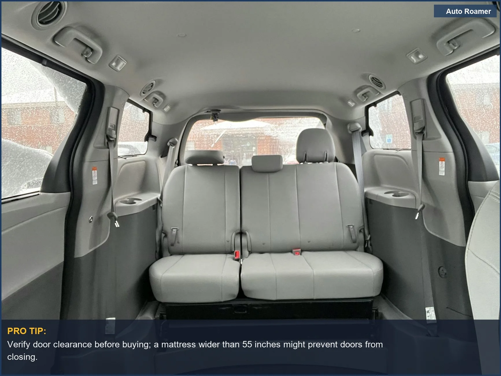 Spacious minivan interior with grey leather seats, perfect for car camping adventures.