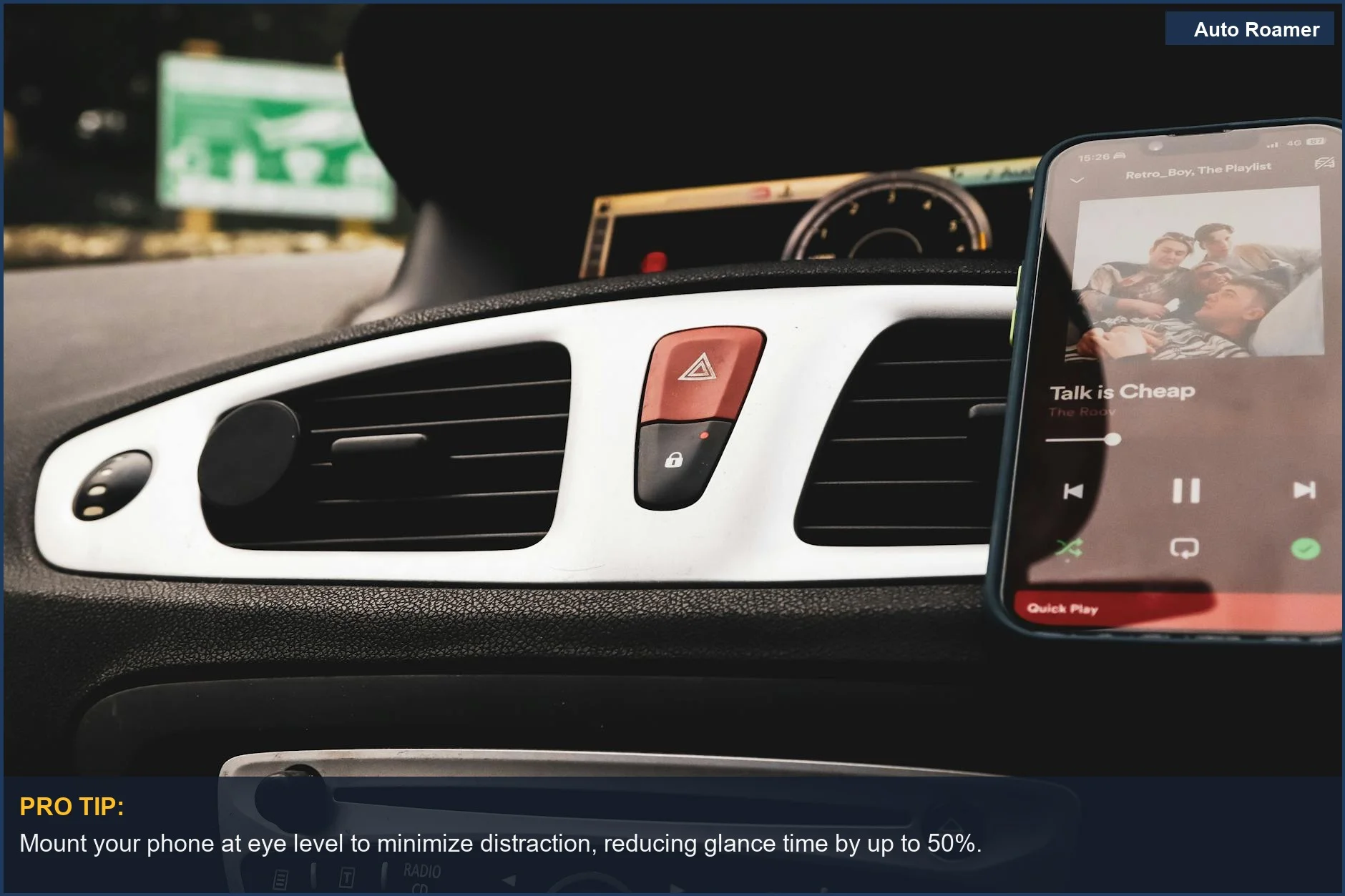 Car interior showcasing a smartphone playing music on Spotify, with dashboard controls in the foreground.