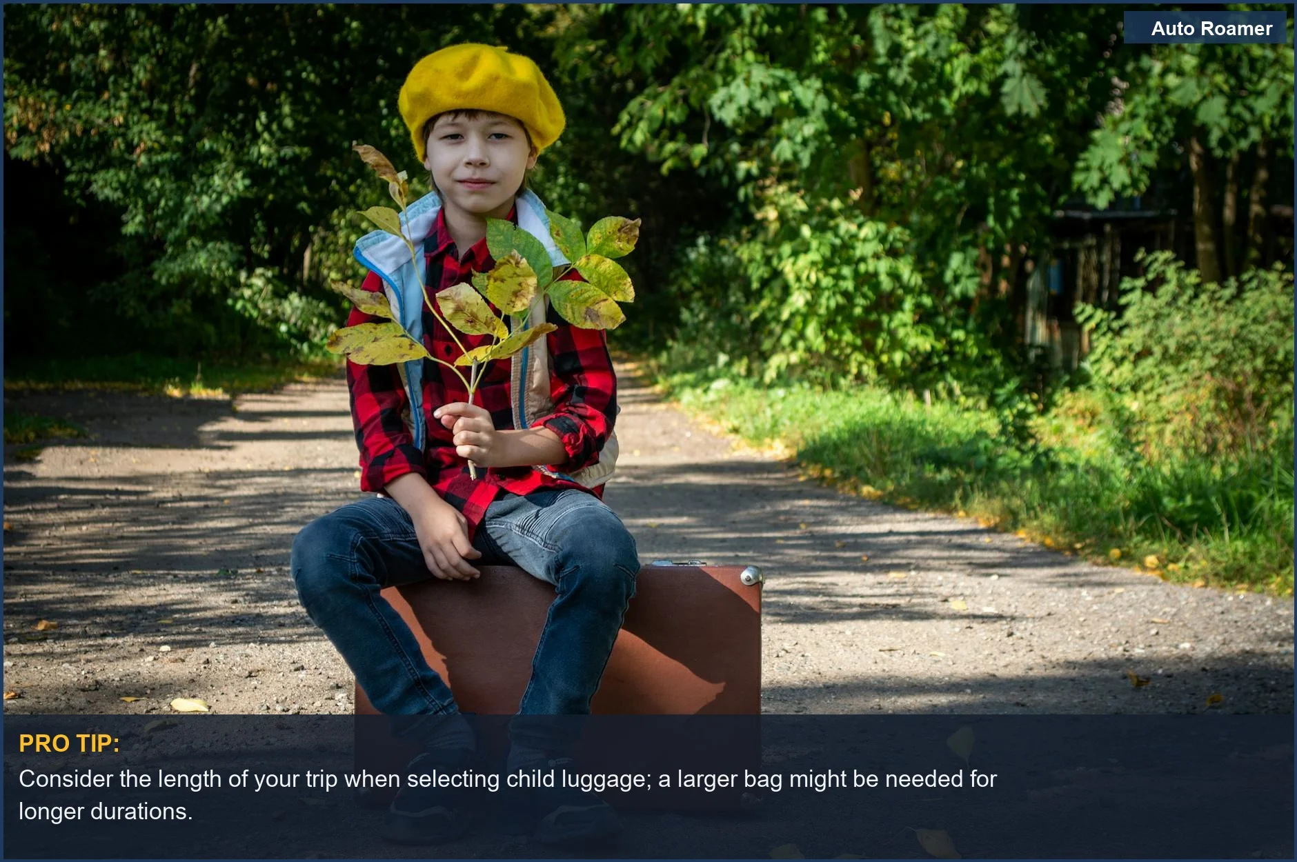 Child sitting on a suitcase outdoors, enjoying nature and ready for travel with their own child luggage.