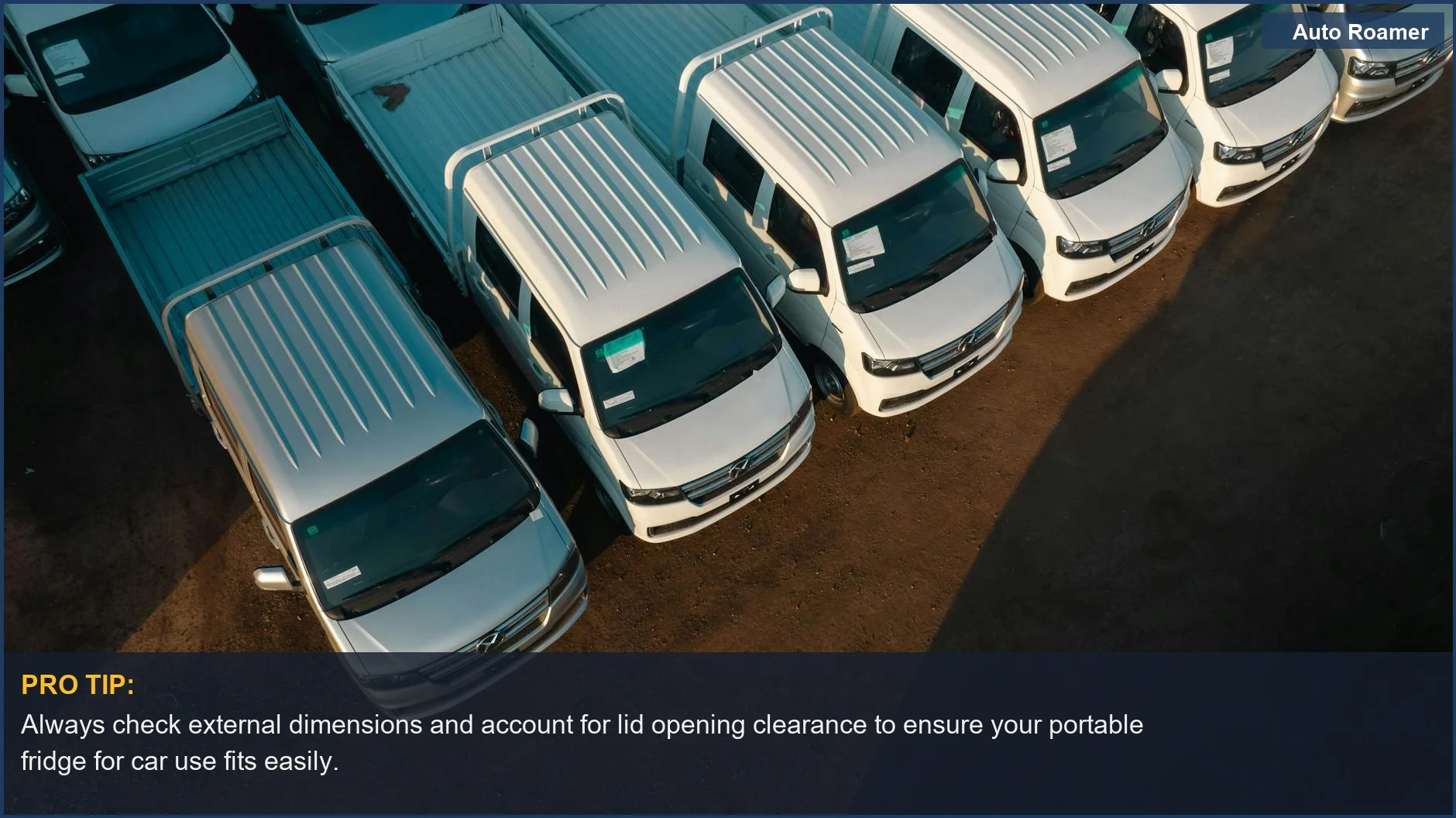 Aerial view of white pickup trucks in a parking lot, illustrating the variety of vehicles that might need a dual zone fridge.