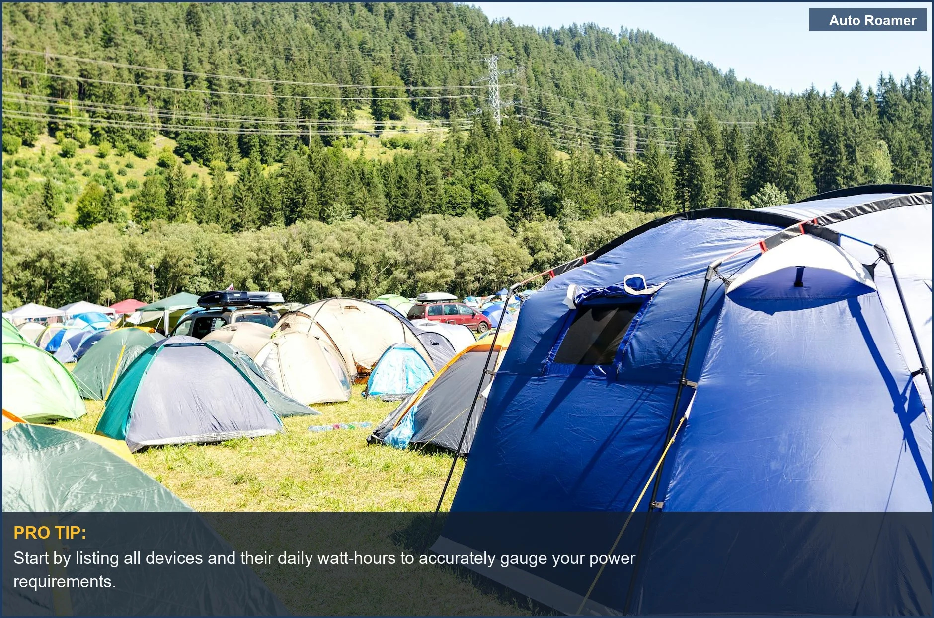 Expansive green valley campsite with tents and mountains, illustrating extended car camping power needs.