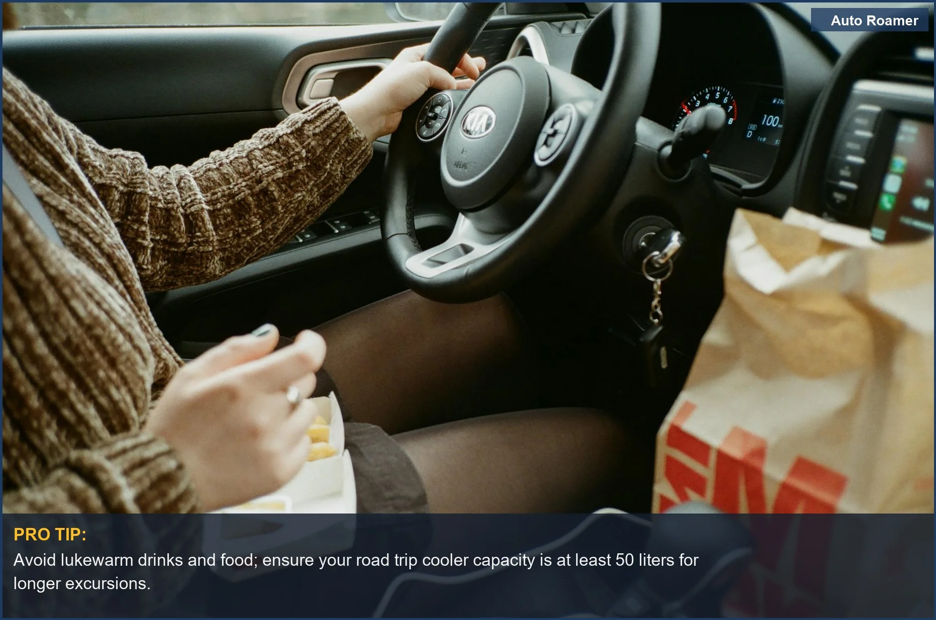 Woman eating in car on road trip, highlighting importance of adequate road trip cooler capacity.