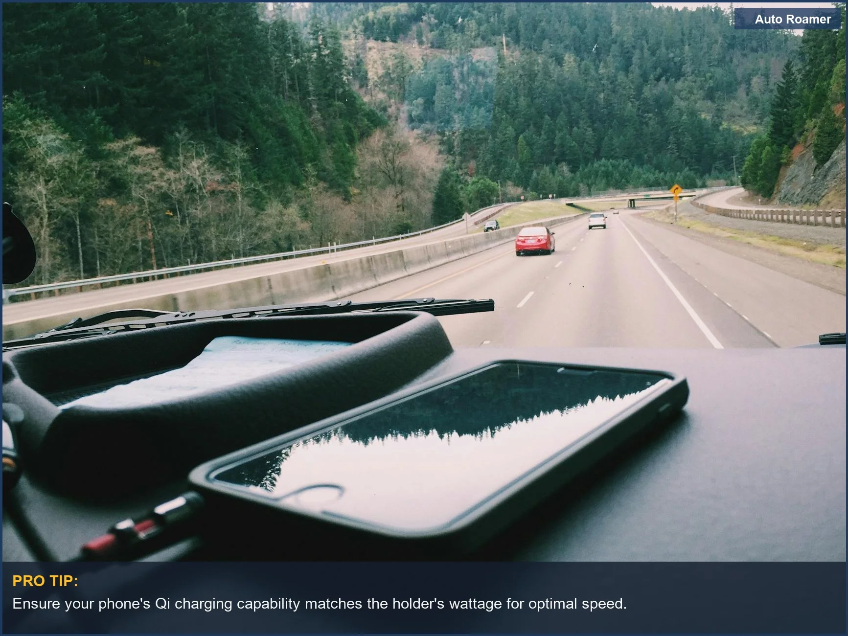 Smartphone charging wirelessly on car dashboard during scenic forest highway road trip, illustrating charging watts.