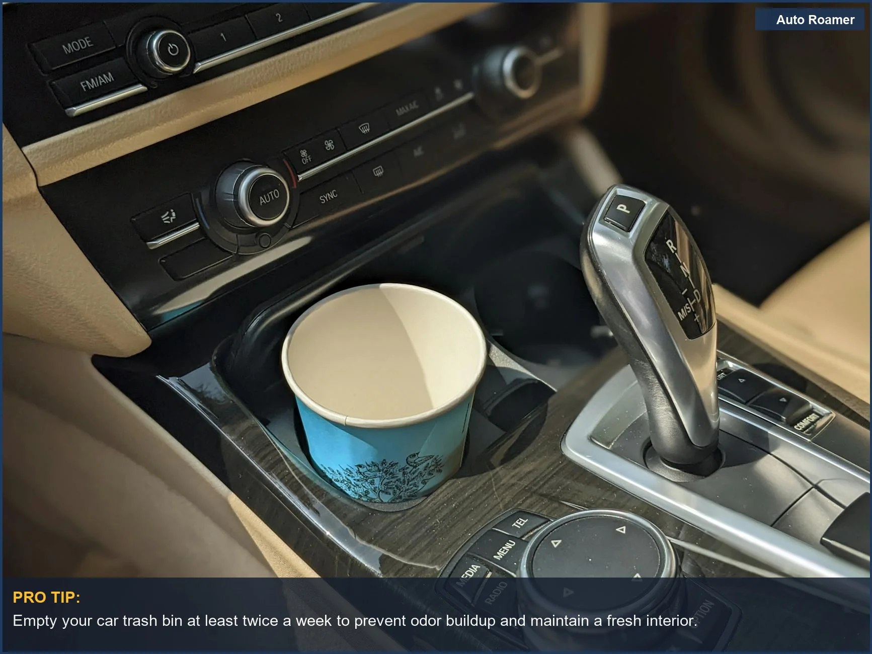 Close-up of a car interior with a trash bin and disposable cup, illustrating the need for clean car trash bin practices.