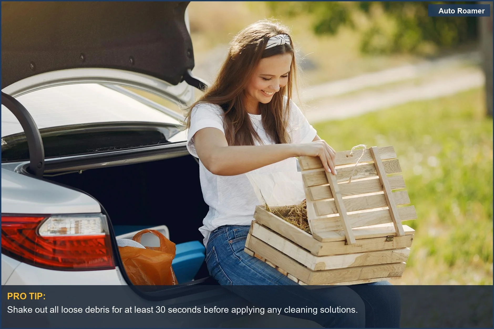 Woman happily unloading camping gear from an SUV trunk, ready to clean the cargo liner.