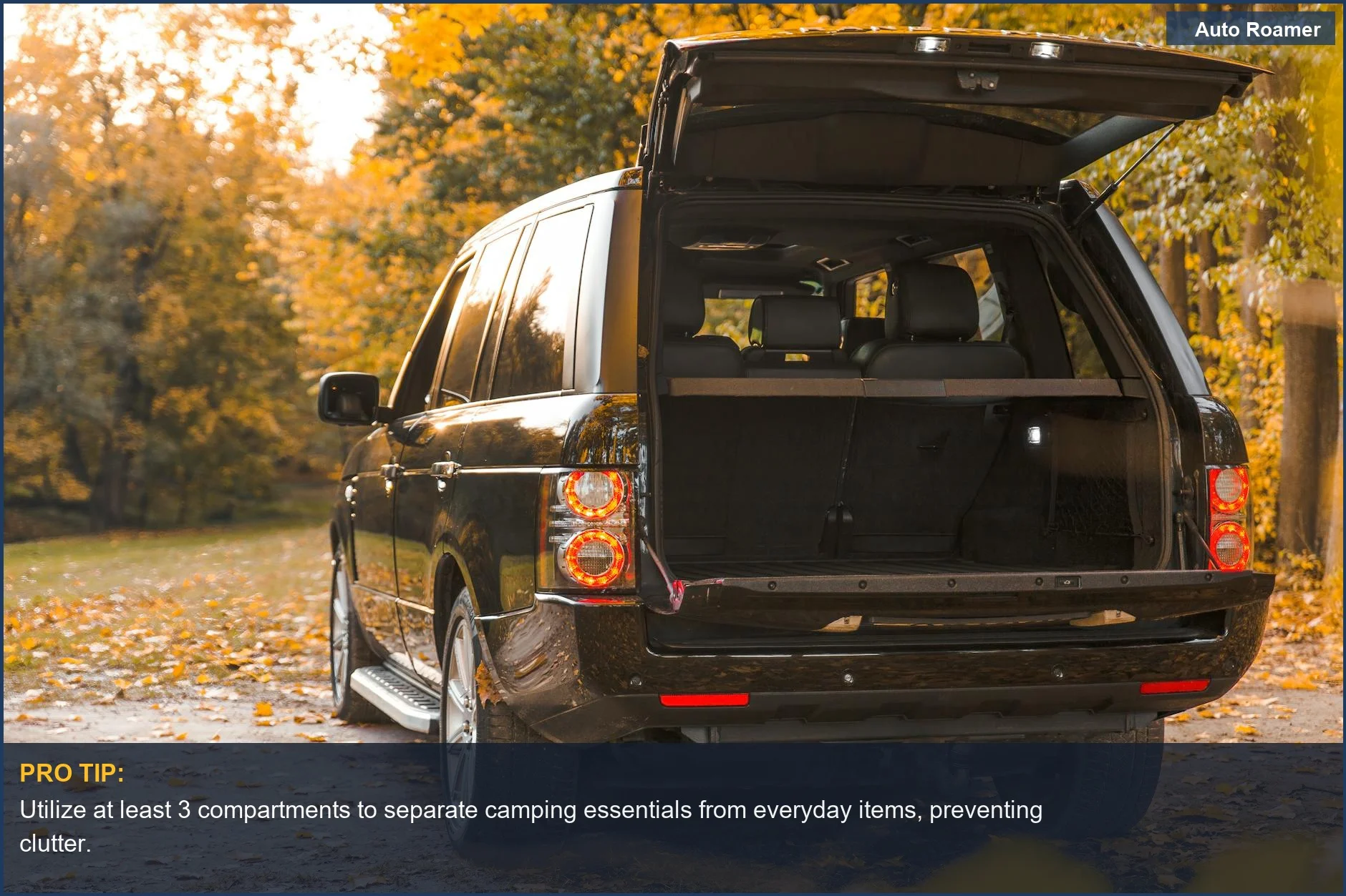 Black SUV's trunk open in an autumn forest, showing space-saving trunk solutions for outdoor adventures.